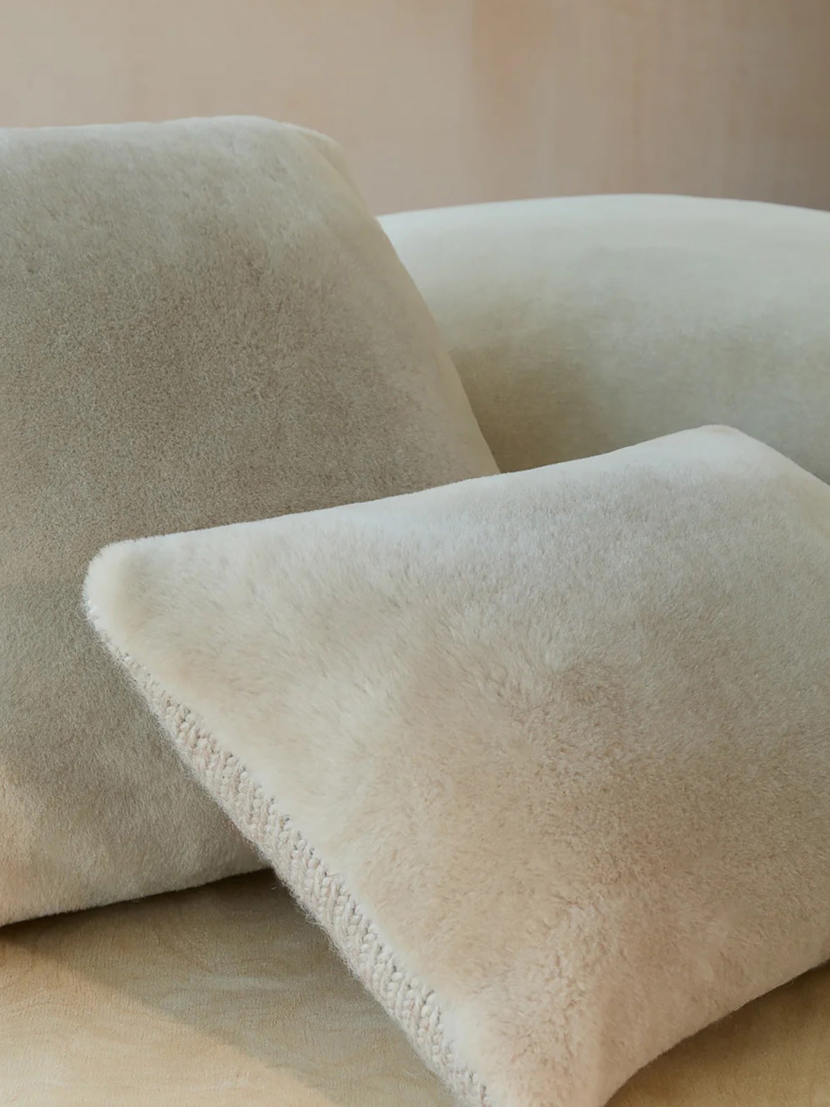 Beige Shearling & Knit Lumbar Cushion | Home | Gushlow & Cole - stack of cushions on sofa