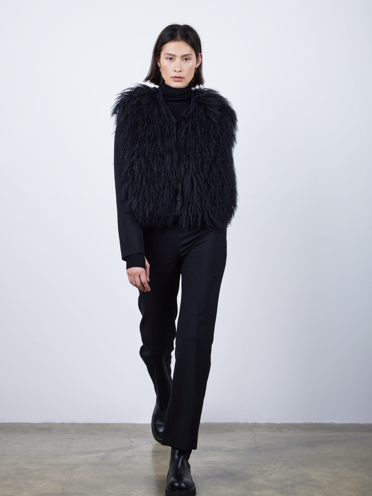 Black Mongolian Shearling Gilet | Womens | Gushlow & Cole-model wearing gilet walking front