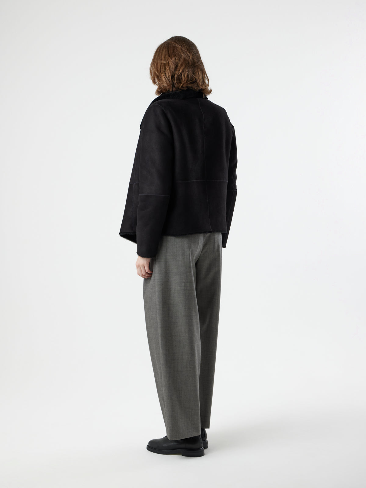 back view of woman wearing Black Blanket Shawl Shearling Jacket by gushlow & cole on white background