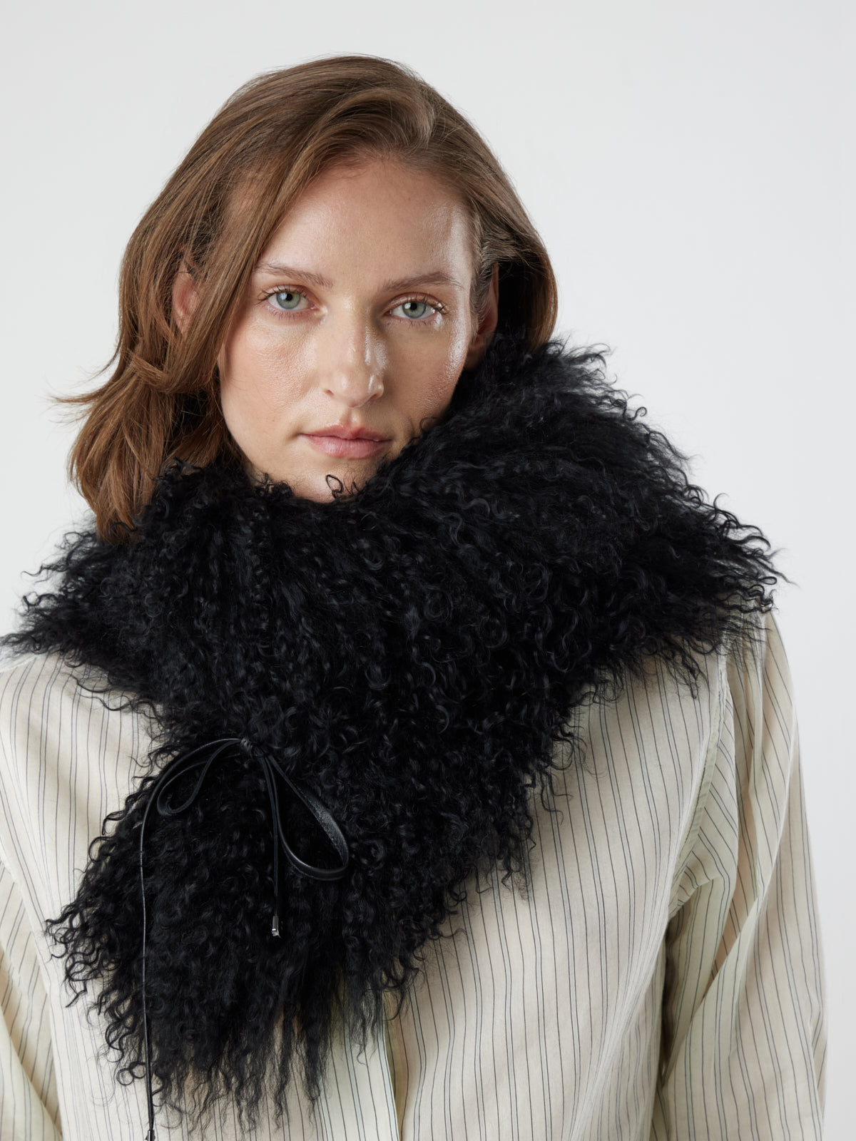 woman wearing black Mongolian Shearling sheepskin Shawl Scarf by gushlow & Cole as snood