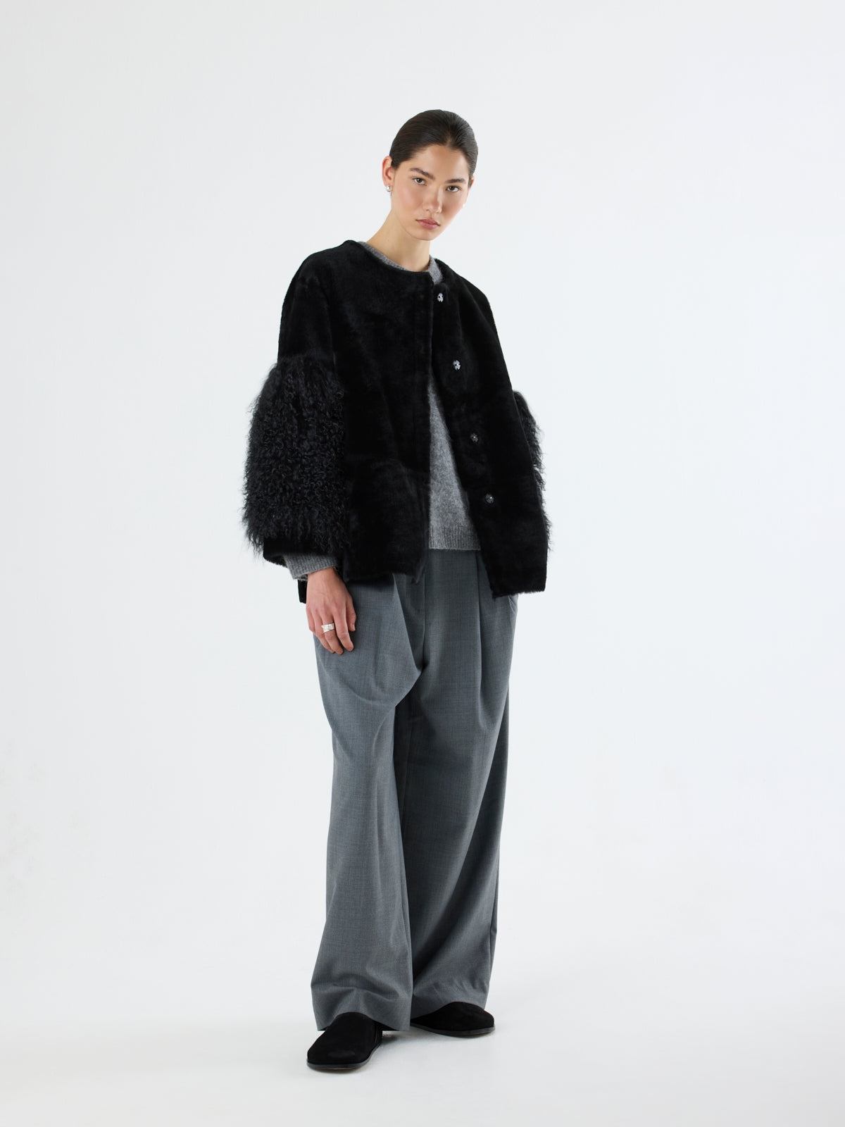 woman wearing black Shearling Pom Jacket by gushlow & cole on white background