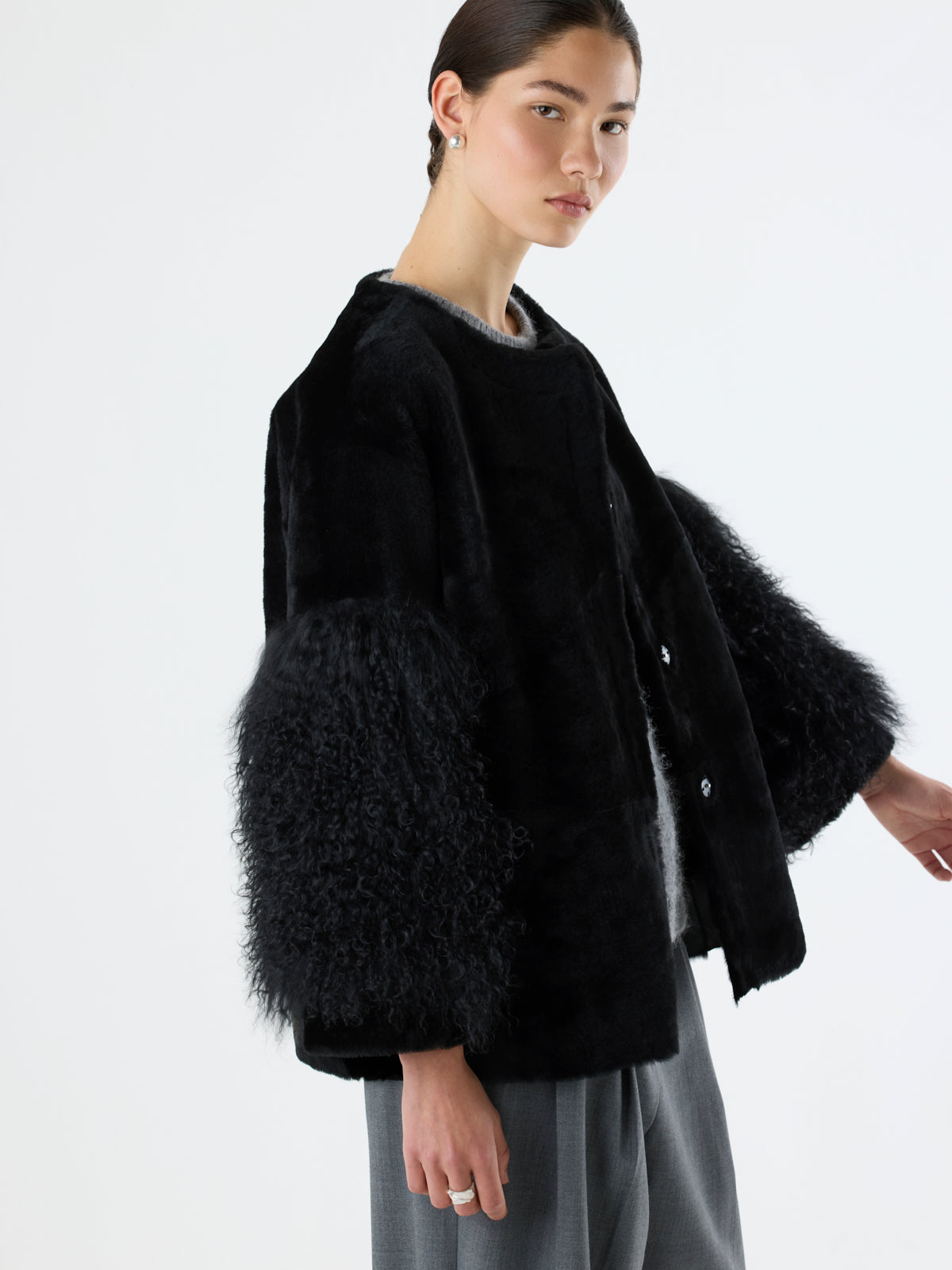 crop in of woman wearing black Shearling Pom Jacket by gushlow & cole on white background