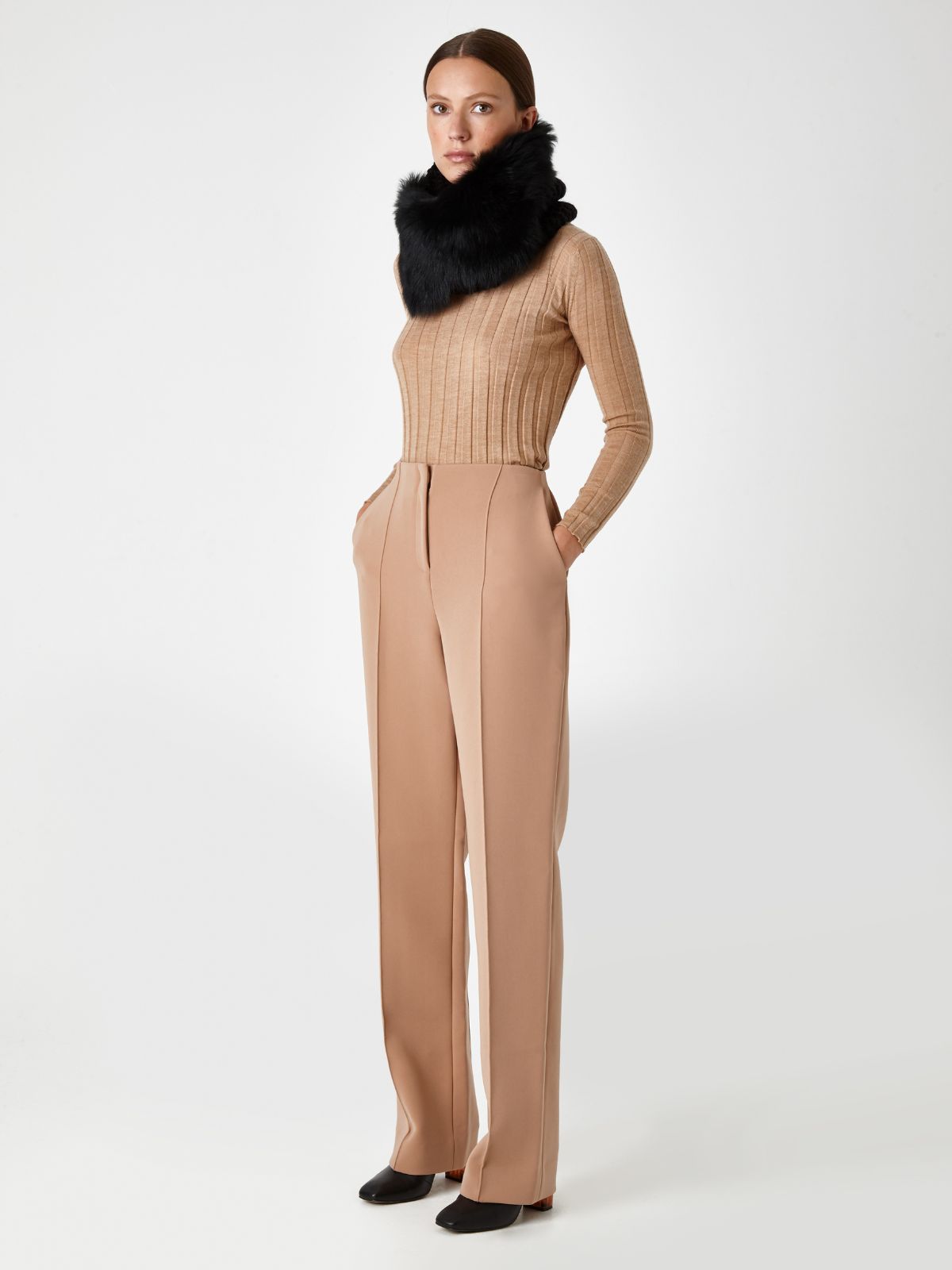 model wearing Black Shearling and Hand Knit Snood by Gushlow & Cole on beige outfit