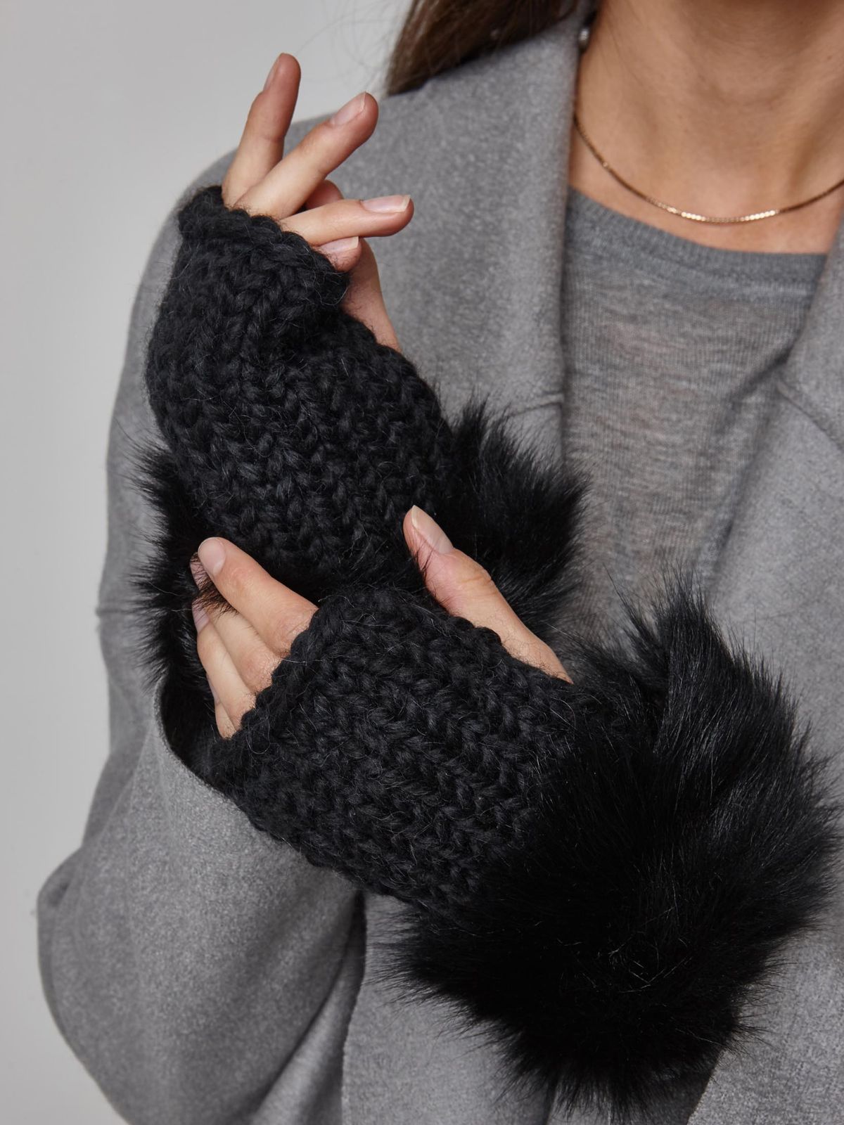 woman wearing pair of Black Shearling and Knit Mittens by Gushlow & Cole over grey coat