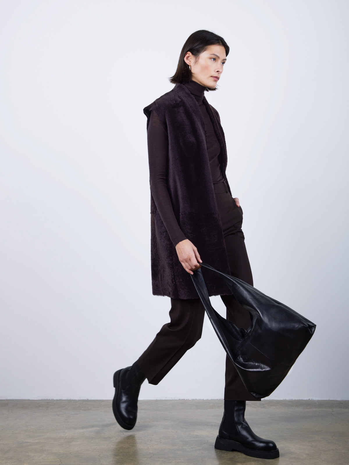 Brown Boxy Shearling Gilet | Womens | Gushlow & Cole- full length model walking with bag