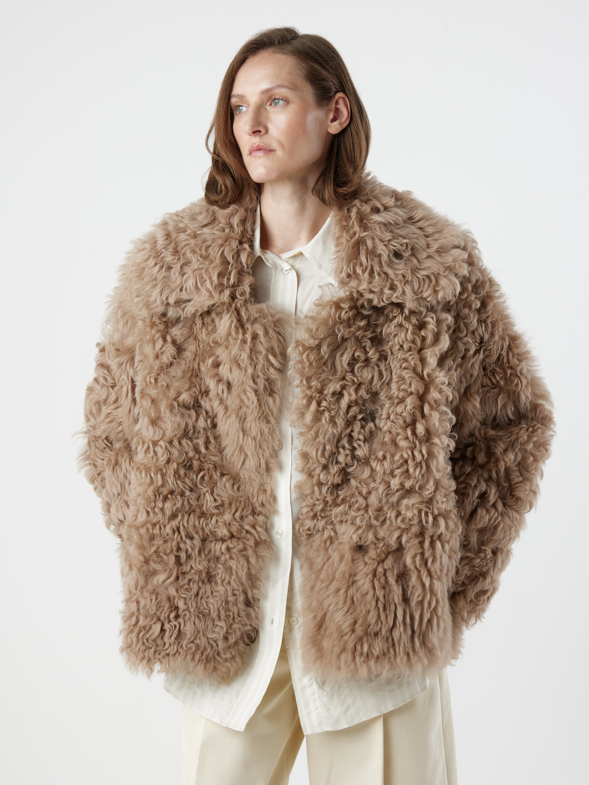 woman wearing Camel Relaxed Fit Curly Shearling Jacket by gushlow & cole / curly sheepskin Jacket