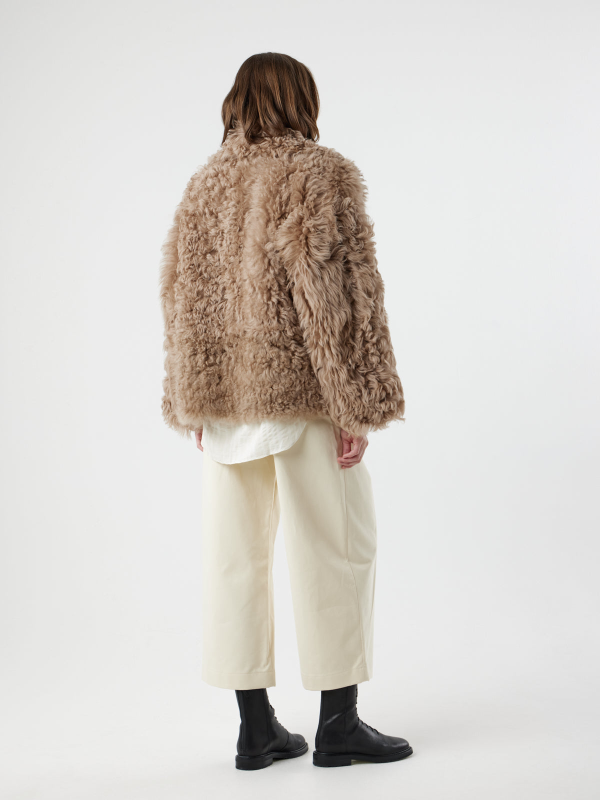 back view of woman wearing Camel Relaxed Fit Curly Shearling Jacket by gushlow & cole / curly sheepskin Jacket