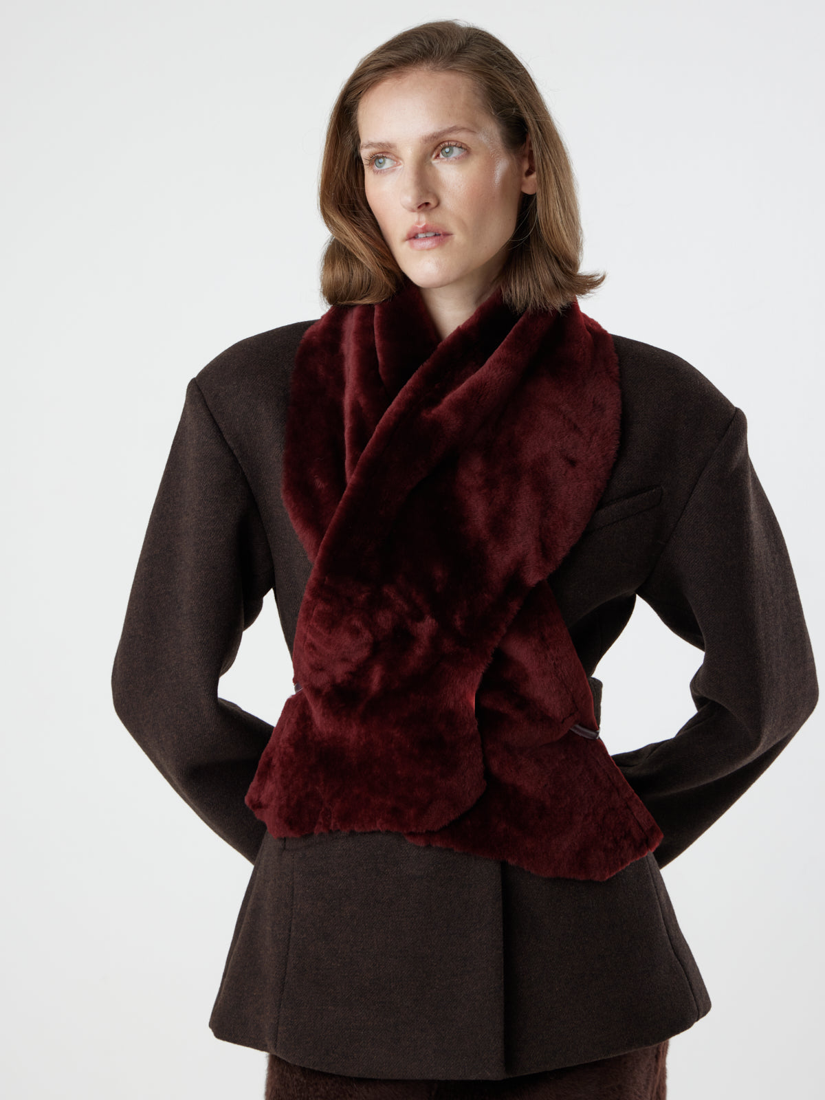 woman wearing cherry red shearling shawl scarf by gushlow & cole, styled crossed over