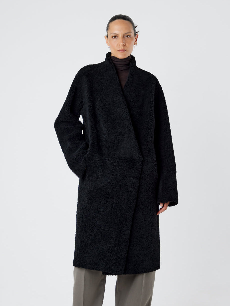Collarless Black Shearling Wrap Coat | Womens | Gushlow & Cole - model length wool out coat closed