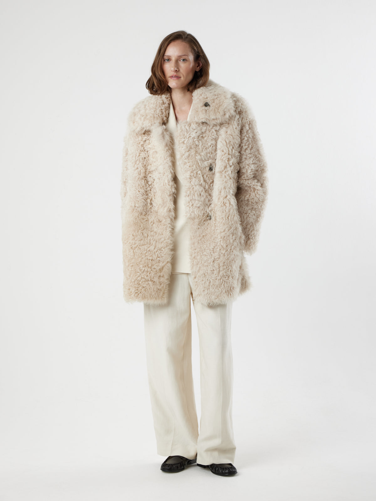 women on white background wearing Cream Relaxed Fit Curly Shearling Coat by gushlow & cole