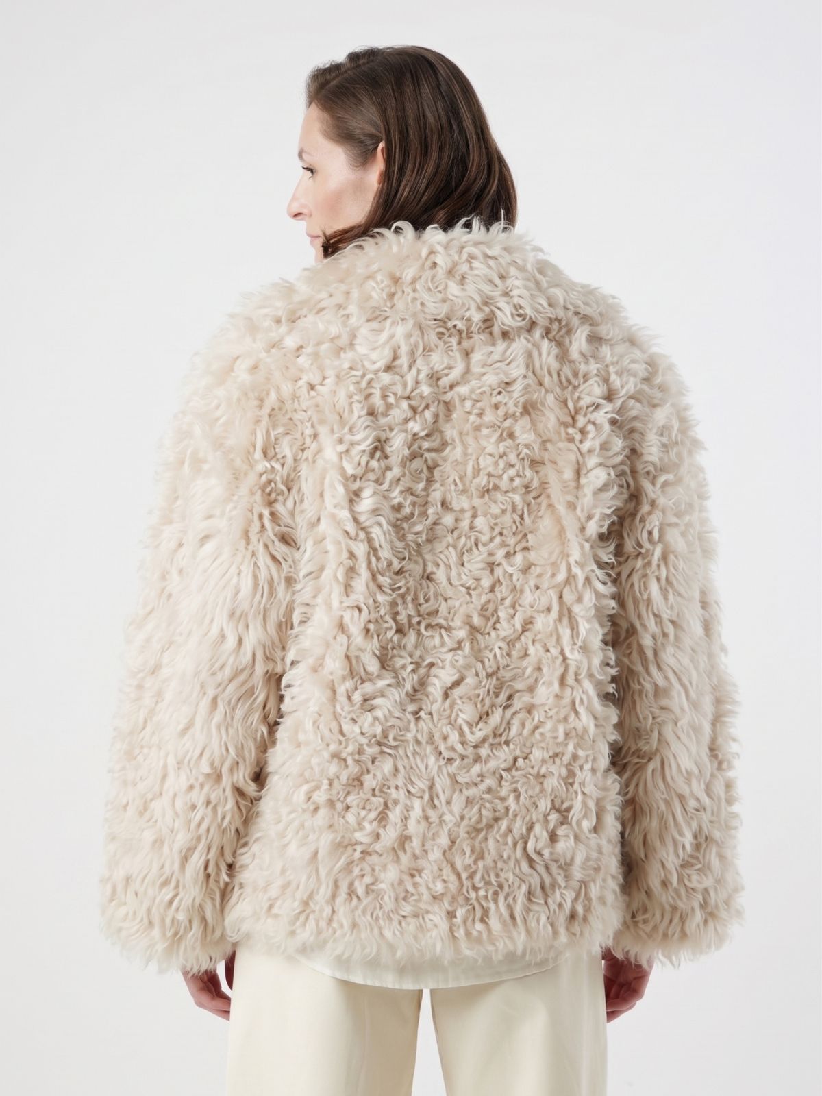 back view of woman wearing Cream Relaxed Fit Curly Shearling Jacket by gushlow & cole / curly sheepskin Jacket