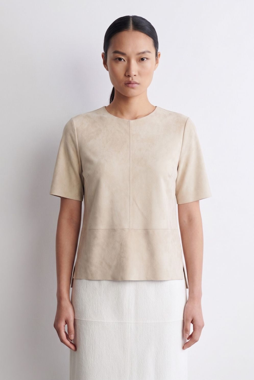 woman wearing cream suede t shirt top and cream skirt on white background by gushlow & cole