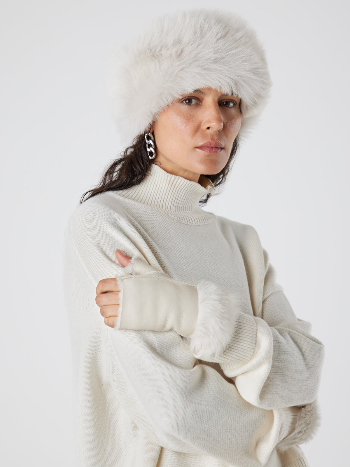 woman wearing Cuffed Mini White Shearling Mittens and white shearling russian hat by gushlow & cole