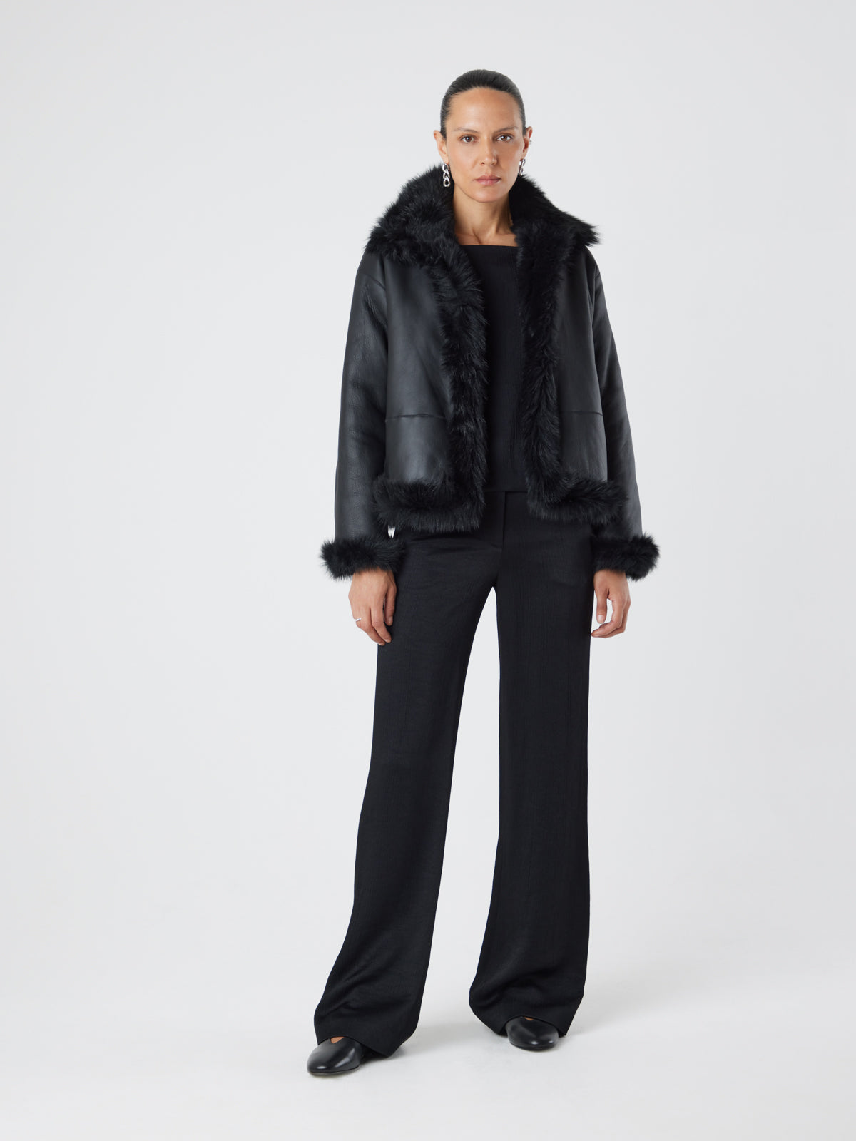 woman wearing Funnel Collar Black Shearling Jacket reversed by gushlow & cole