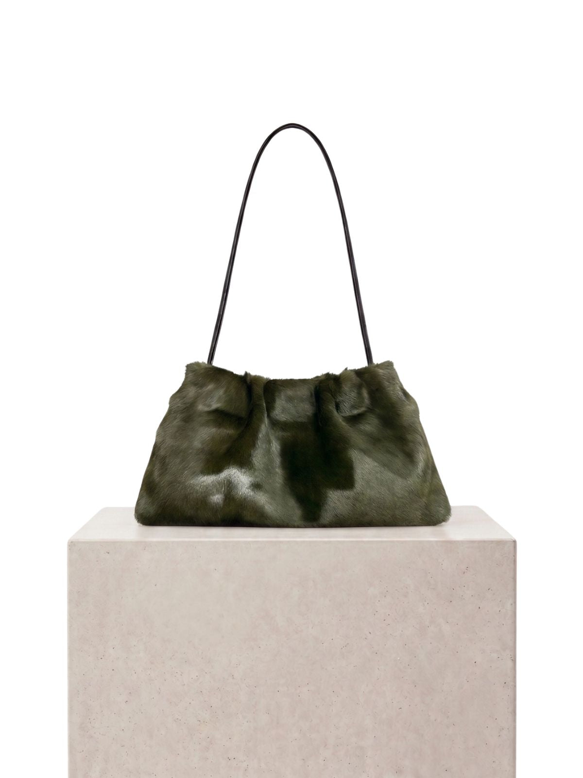 ghia small green shoulder bag made in calfskin on white background and plinth by gushlow & cole