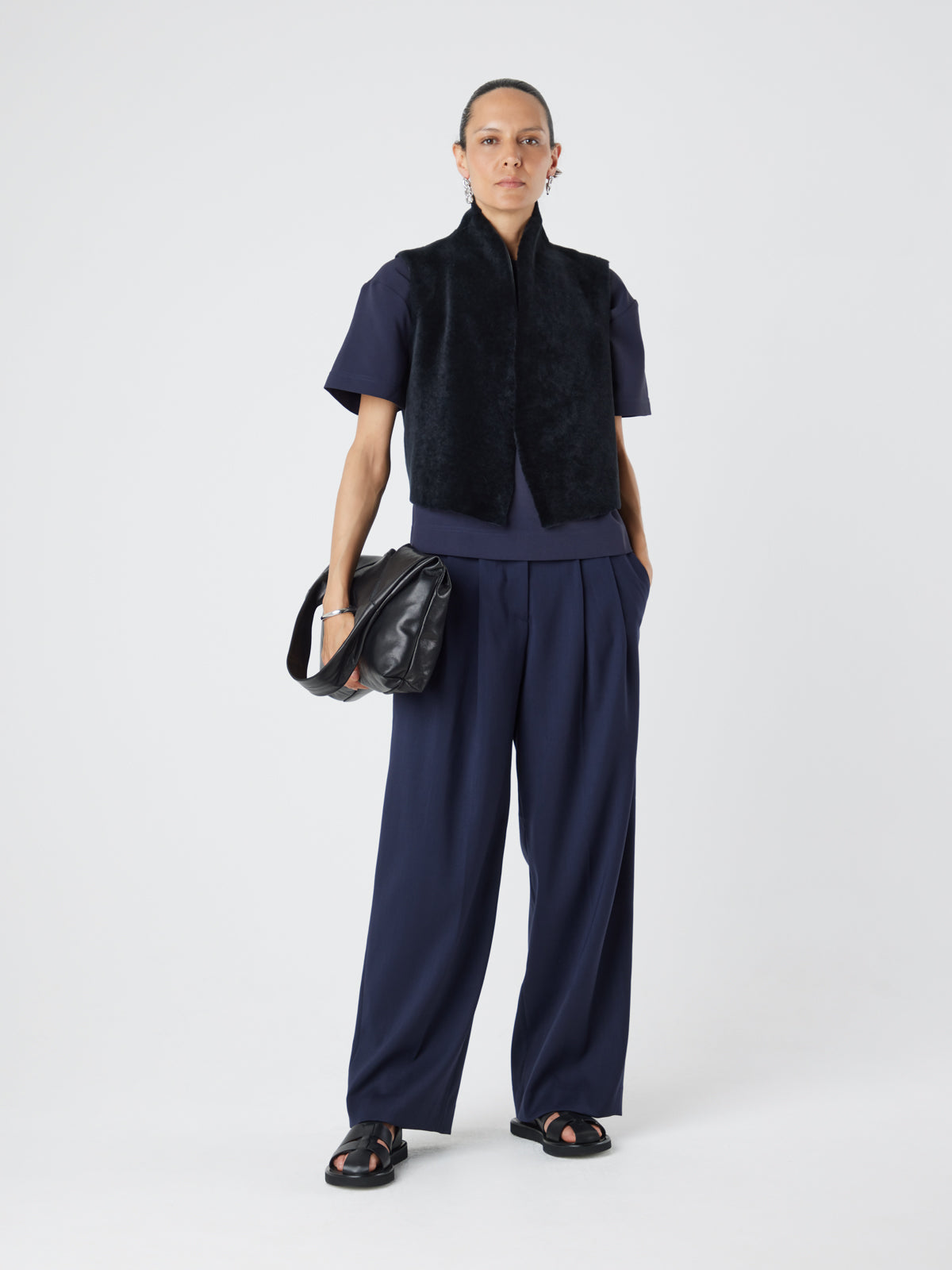 Graphite Black Short Shearling Gilet | Womens | Gushlow & Cole - model front full length with bag