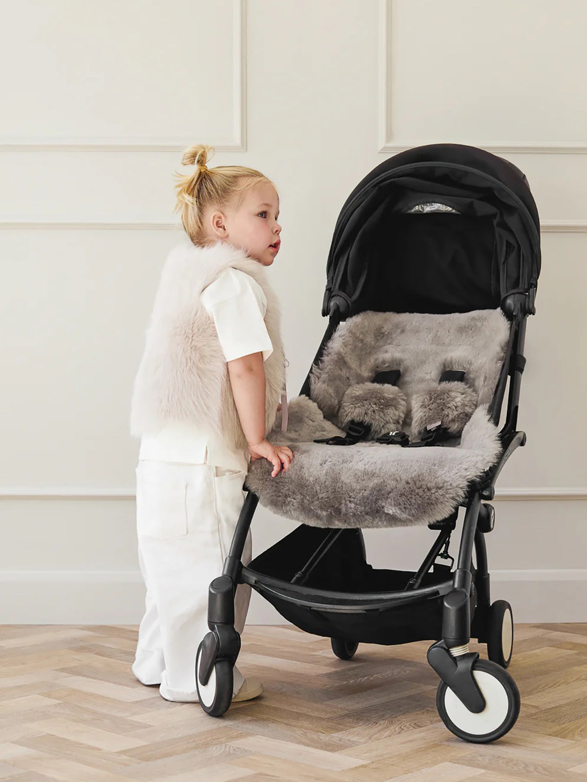 Grey Sheepskin Pram Liner & Strap Cover | Kids | Gushlow & Cole - model next to pram liner side
