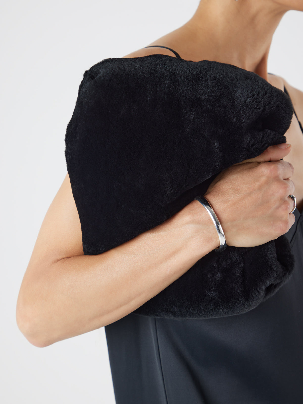 Merino Soft Black Shearling Clutch Bag | Womens | Gushlow & Cole - model crop holding bag