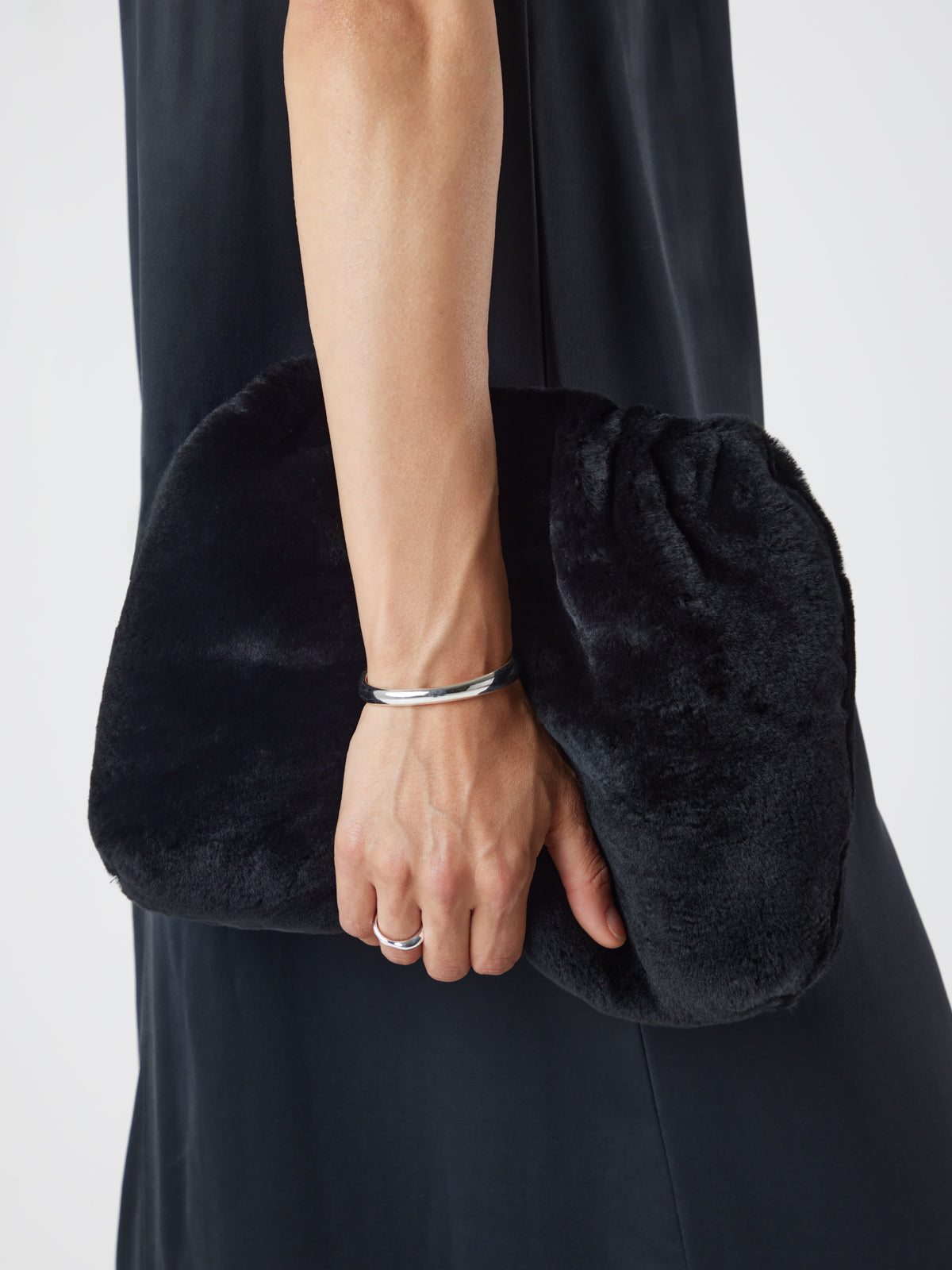 Merino Soft Black Shearling Clutch Bag | Womens | Gushlow & Cole - model crop holding bag