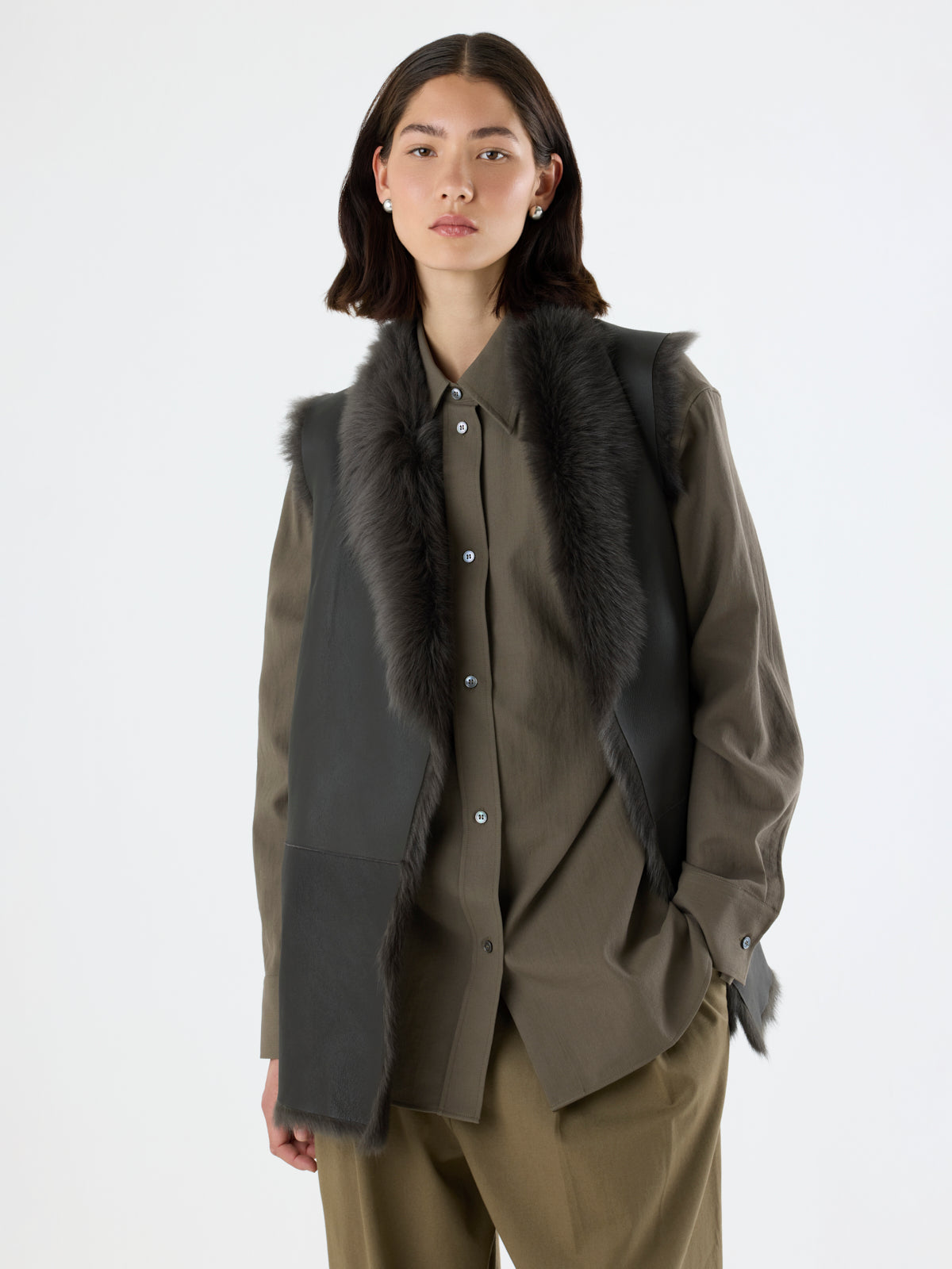 crop in of woman wearing Mid-Length Storm Green Shearling Gilet by gushlow & cole