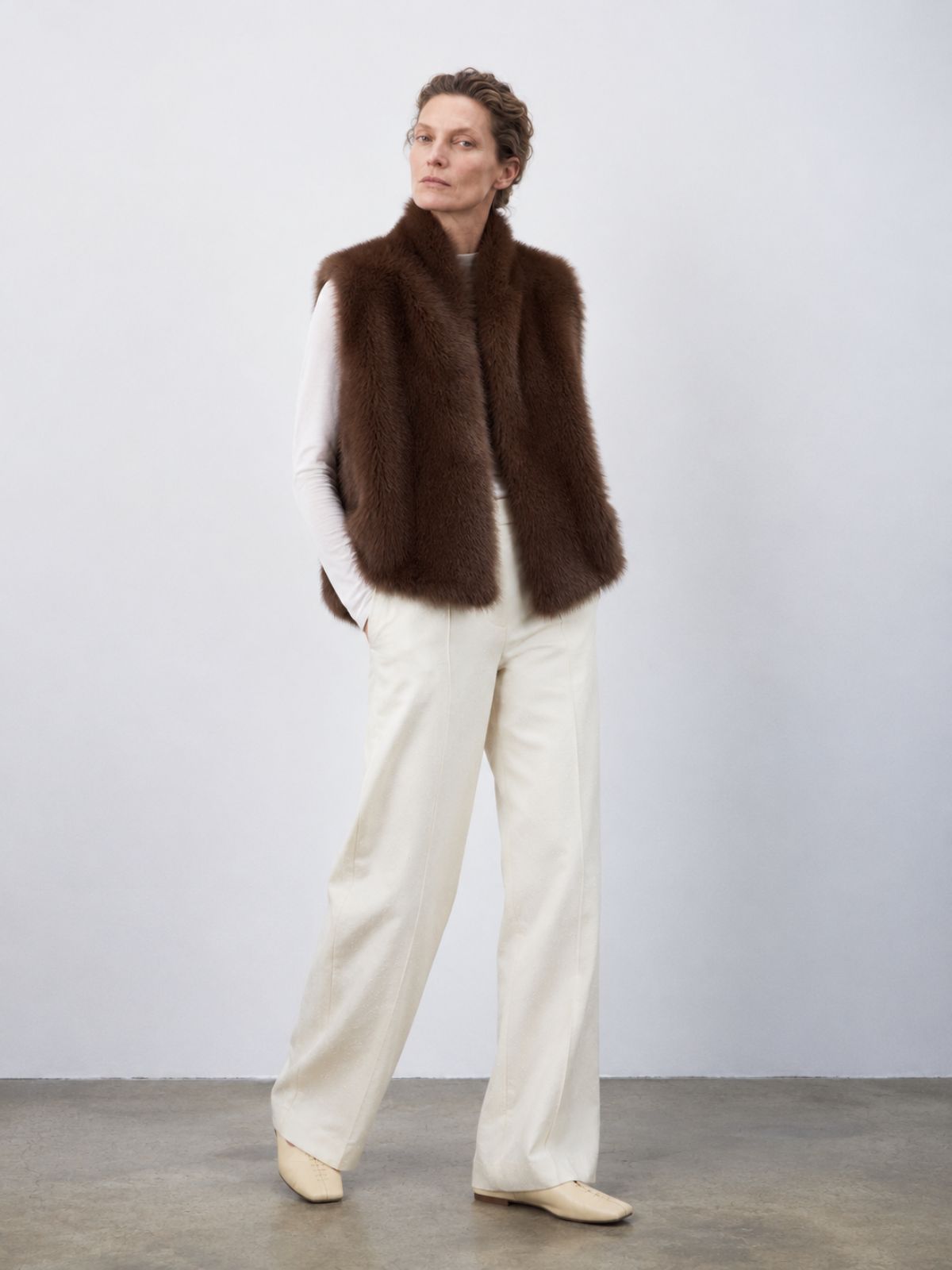 woman wearing natural edge brown shearling gilet by gushlow & cole