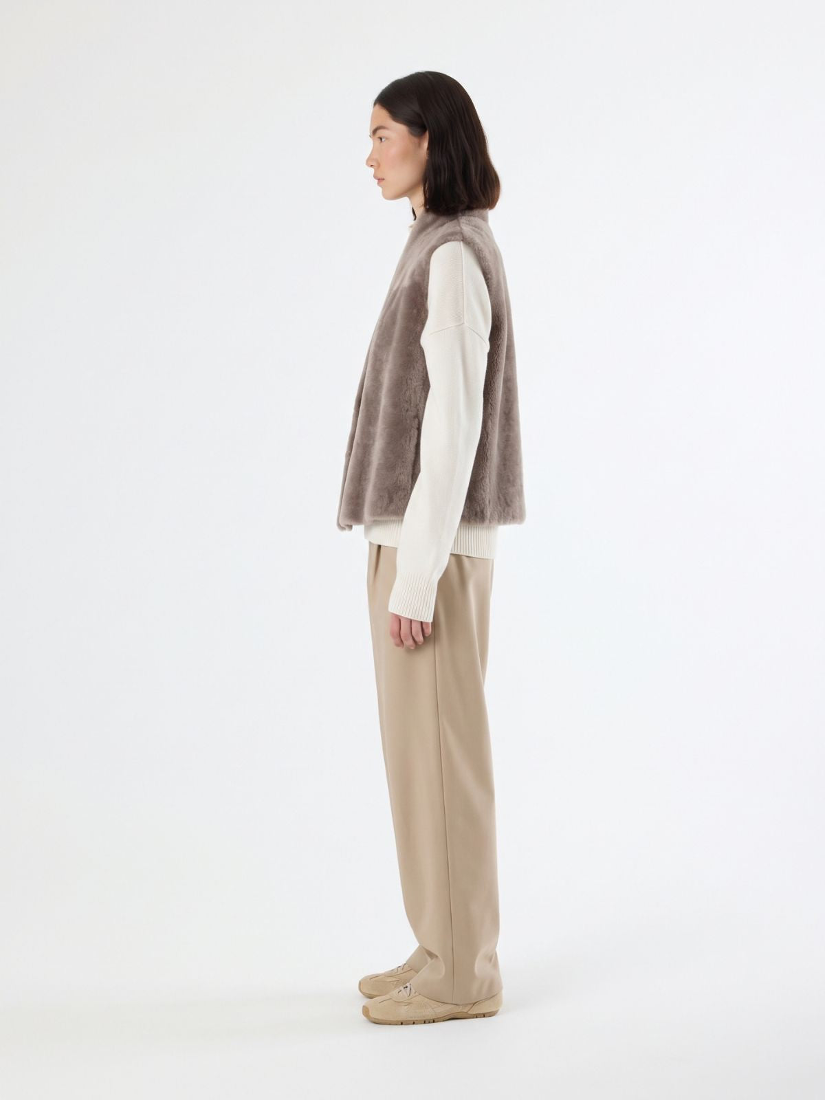 side view of woman wearing natural edge taupe shearling gilet by gushlow & cole