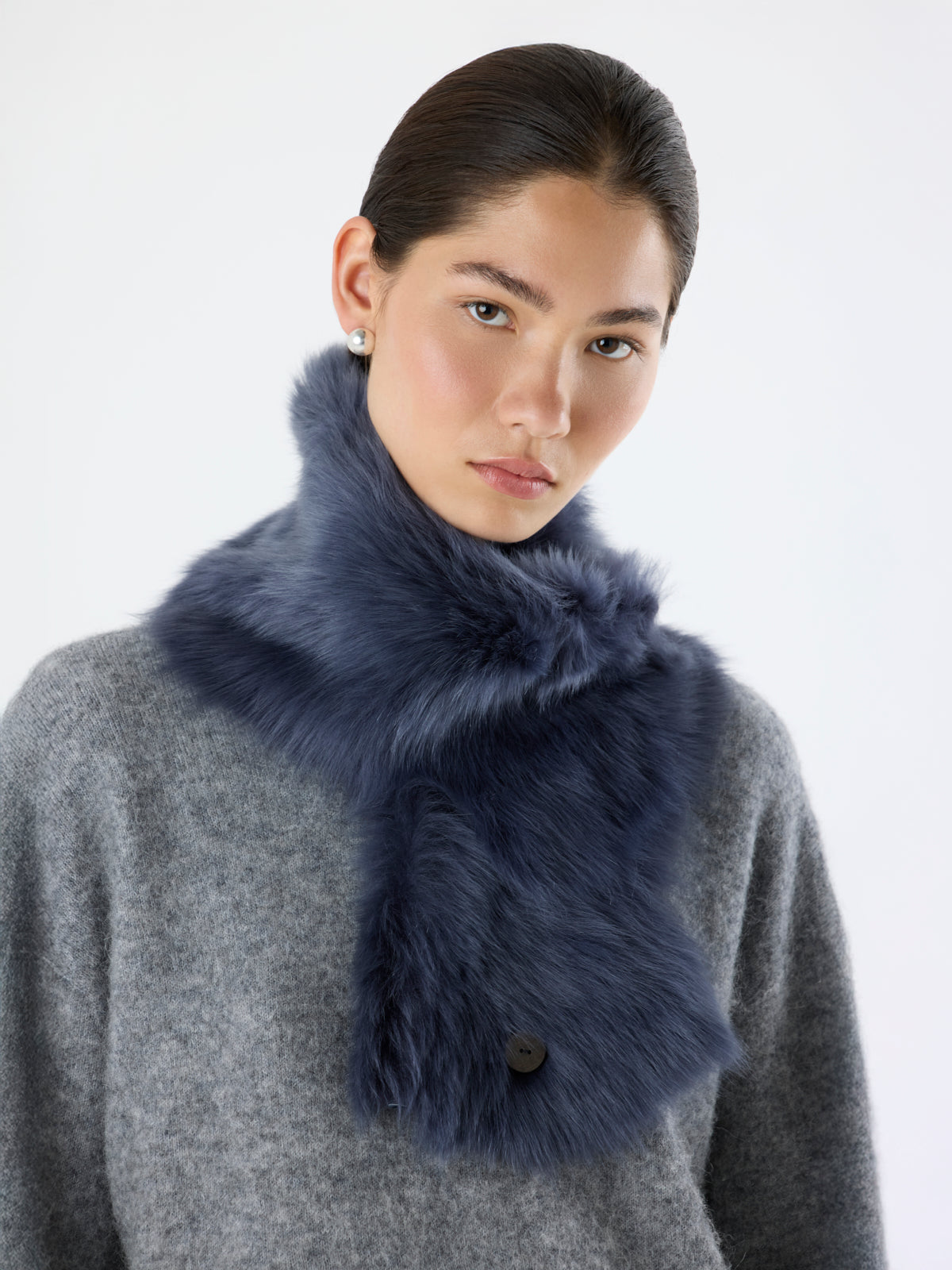 woman wearing Navy Baby Button Shearling Scarf by Gushlow & Cole over grey knit jumper