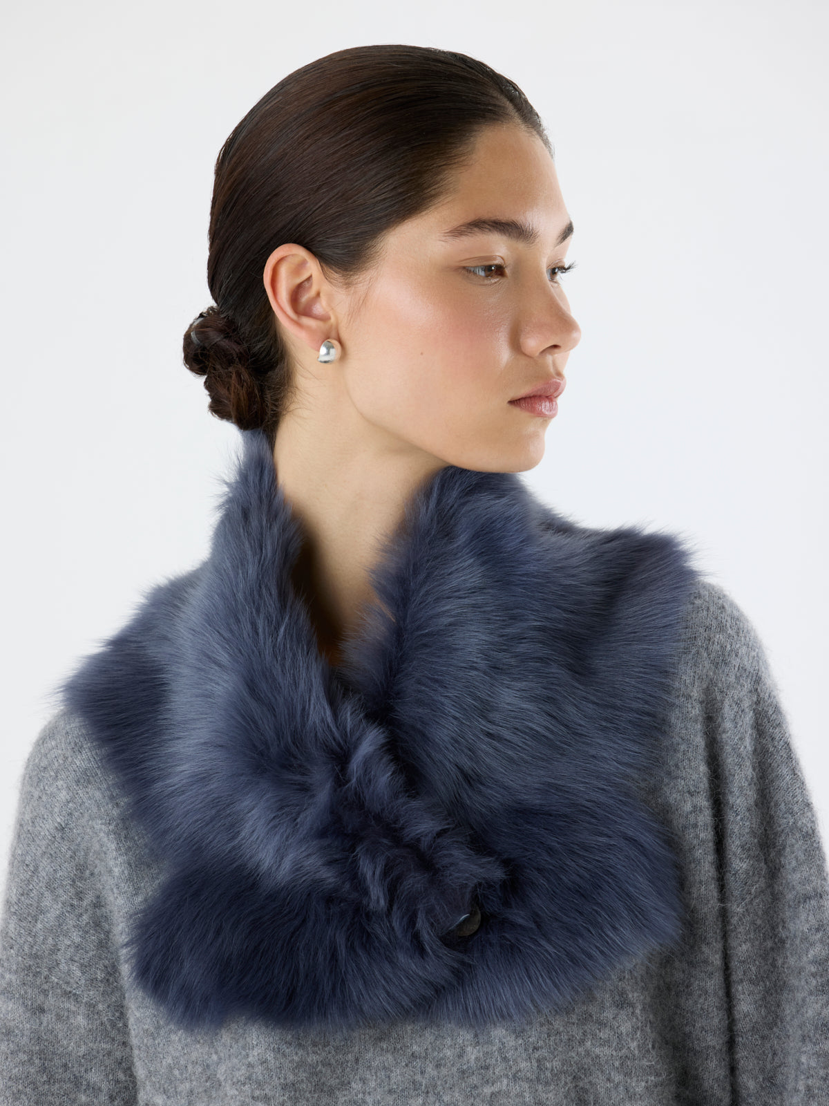 woman wearing Navy Baby Button Shearling Scarf by Gushlow & Cole over grey knit jumper