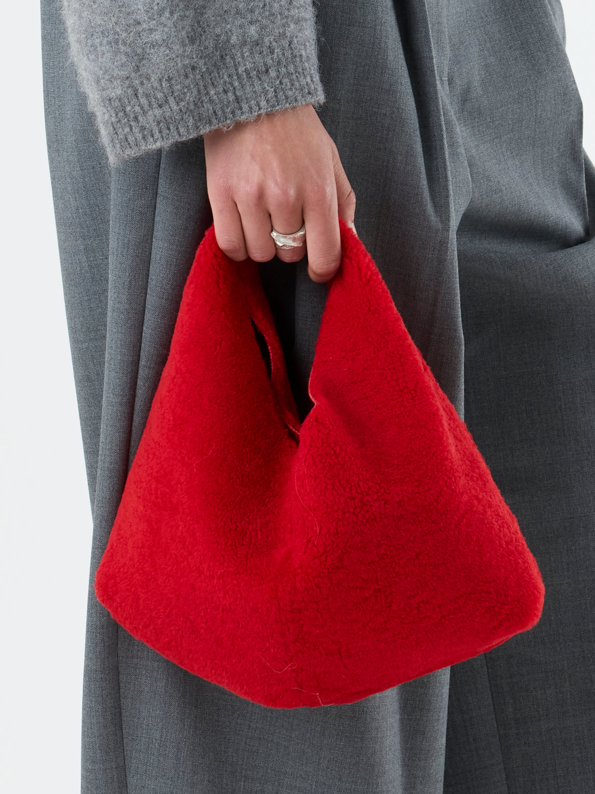 woman holding Red Clara Small Shearling Shoulder Bag by Gushlow & Cole