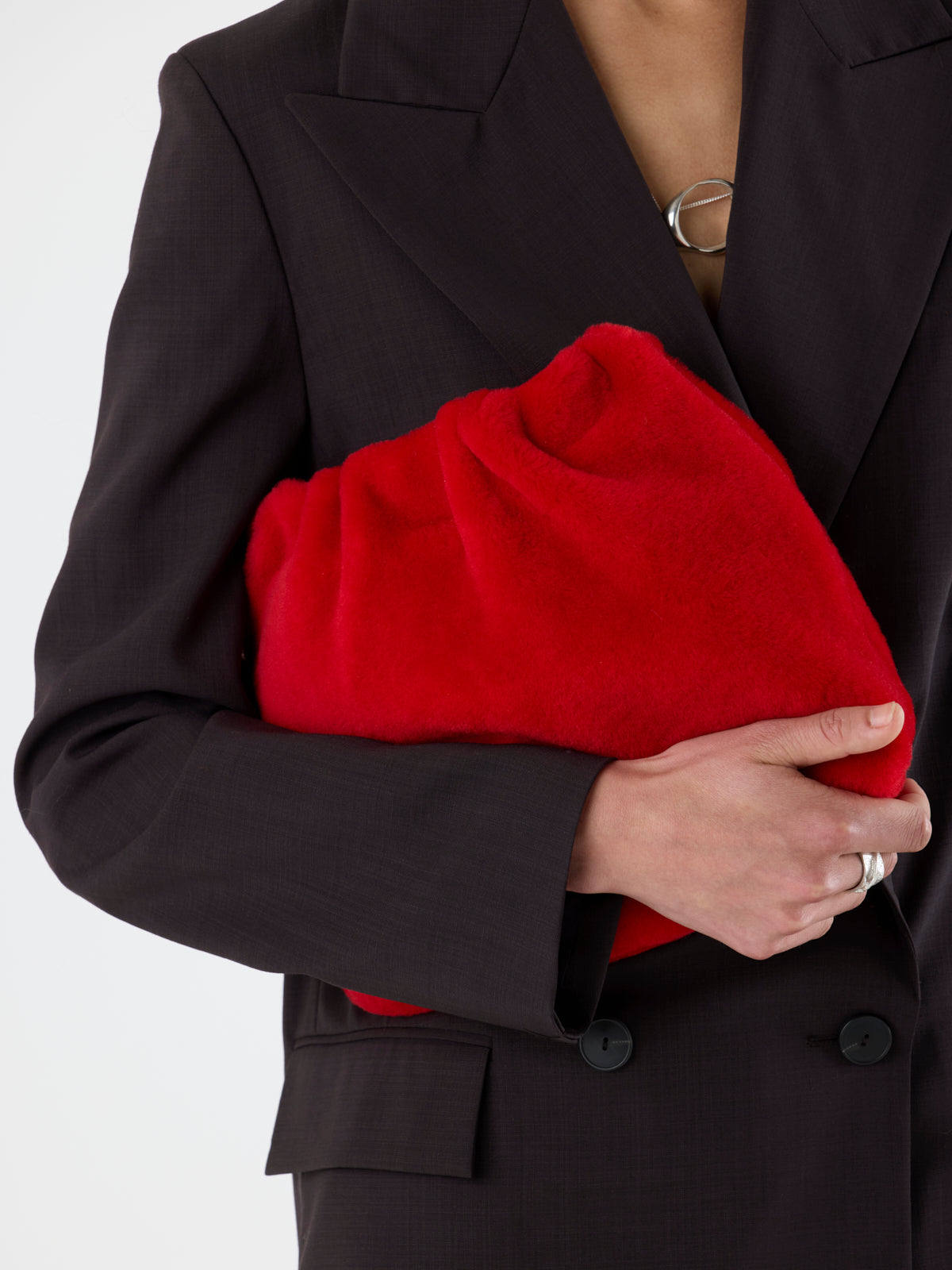 woman wearing Red Merino Soft Shearling Clutch by Gushlow & Cole over brown suit