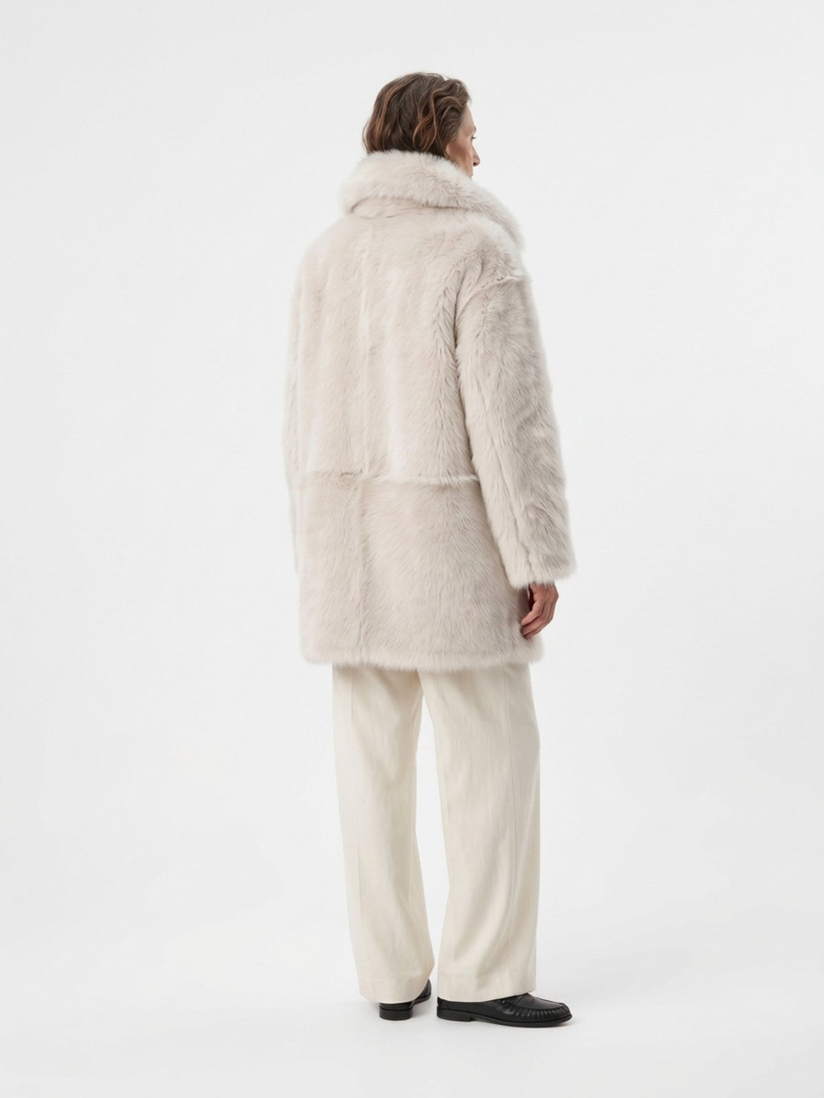 back view of woman wearing relaxed fit white toscana shearling coat by gushlow & cole