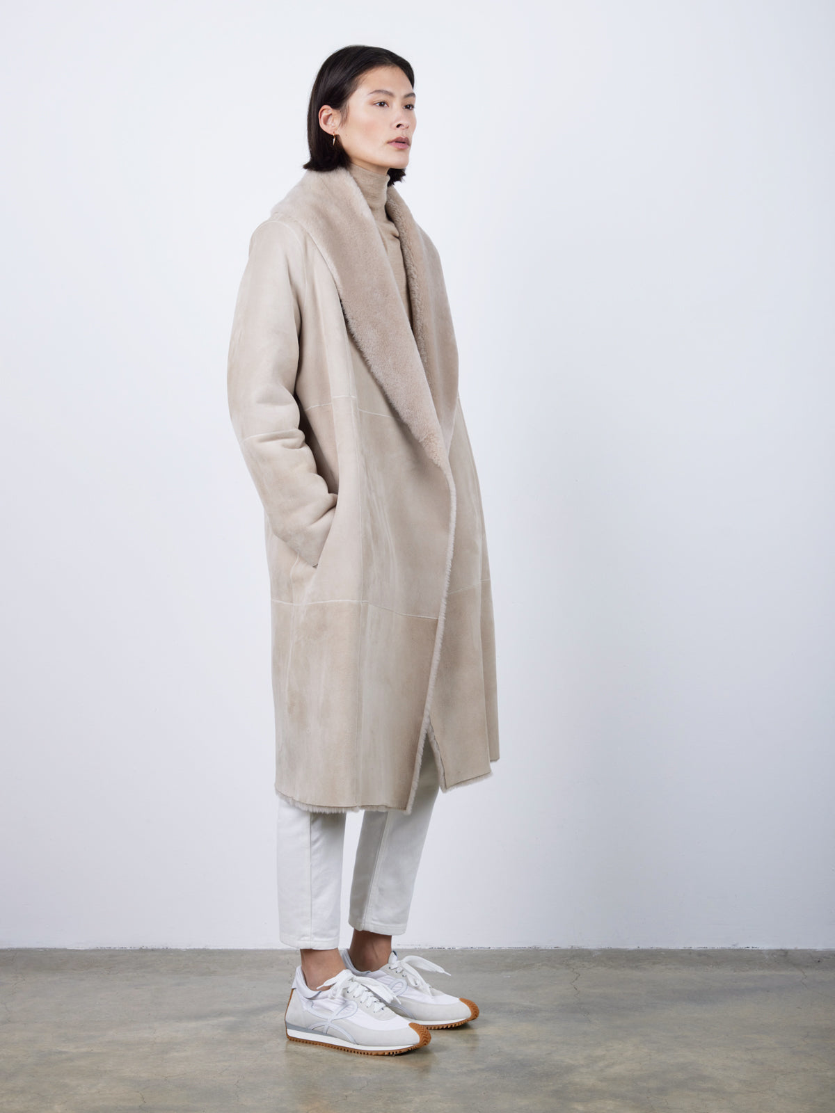 side view of woman wearing merino shearling shawl collar coat blanket shawl coat by gushlow & cole