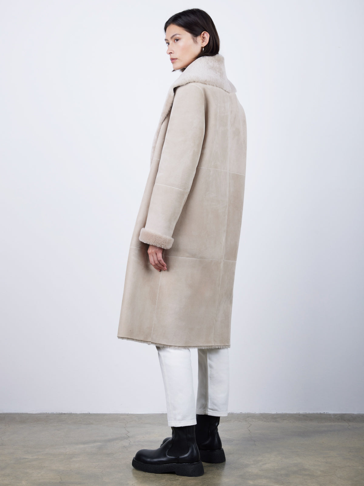 side view of woman wearing merino shearling shawl collar coat blanket shawl coat by gushlow & cole