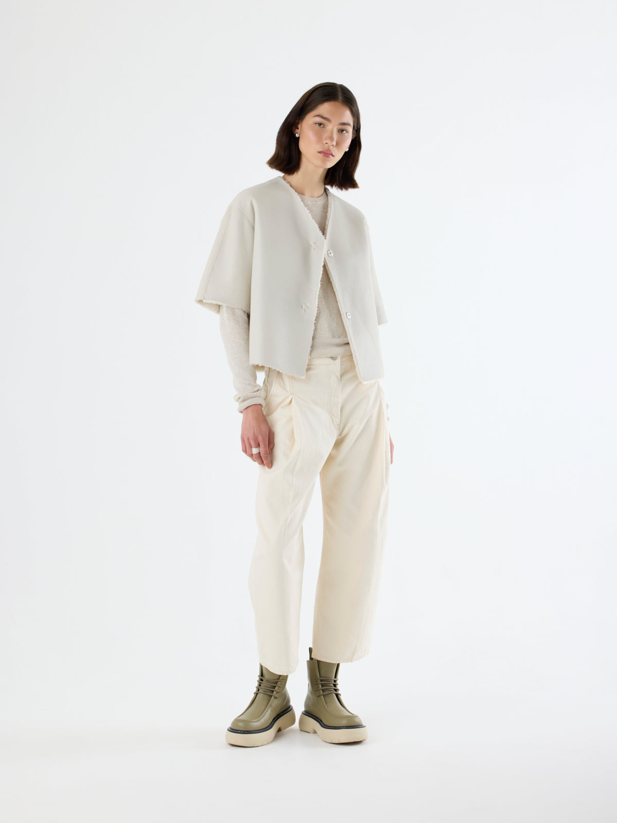 woman wearing short-sleeve white Shearling Cardigan by gushlow & cole on white background