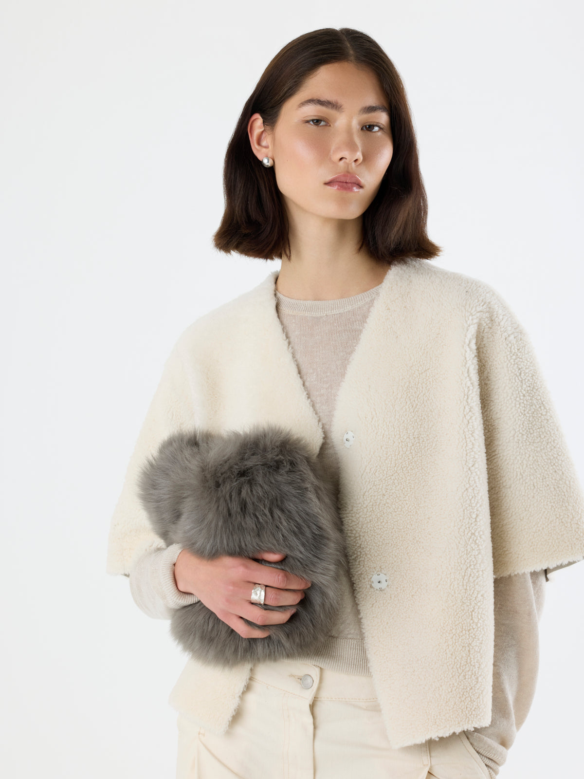 woman holding storm green Soft Shearling Clutch Bag by gushlow & Cole