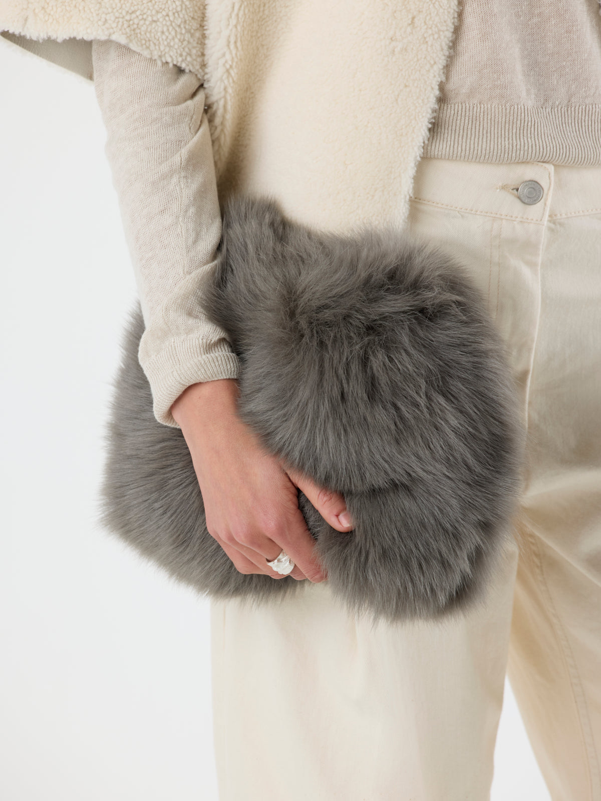 close up of woman holding storm green Soft Shearling Clutch Bag by gushlow & Cole