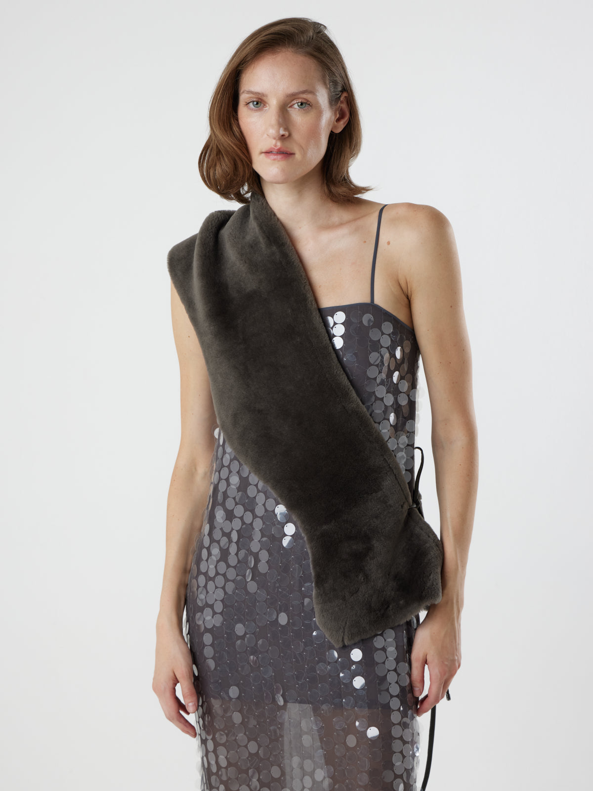 woman wearing storm brown shearling shawl scarf by gushlow & cole, styled as a sash