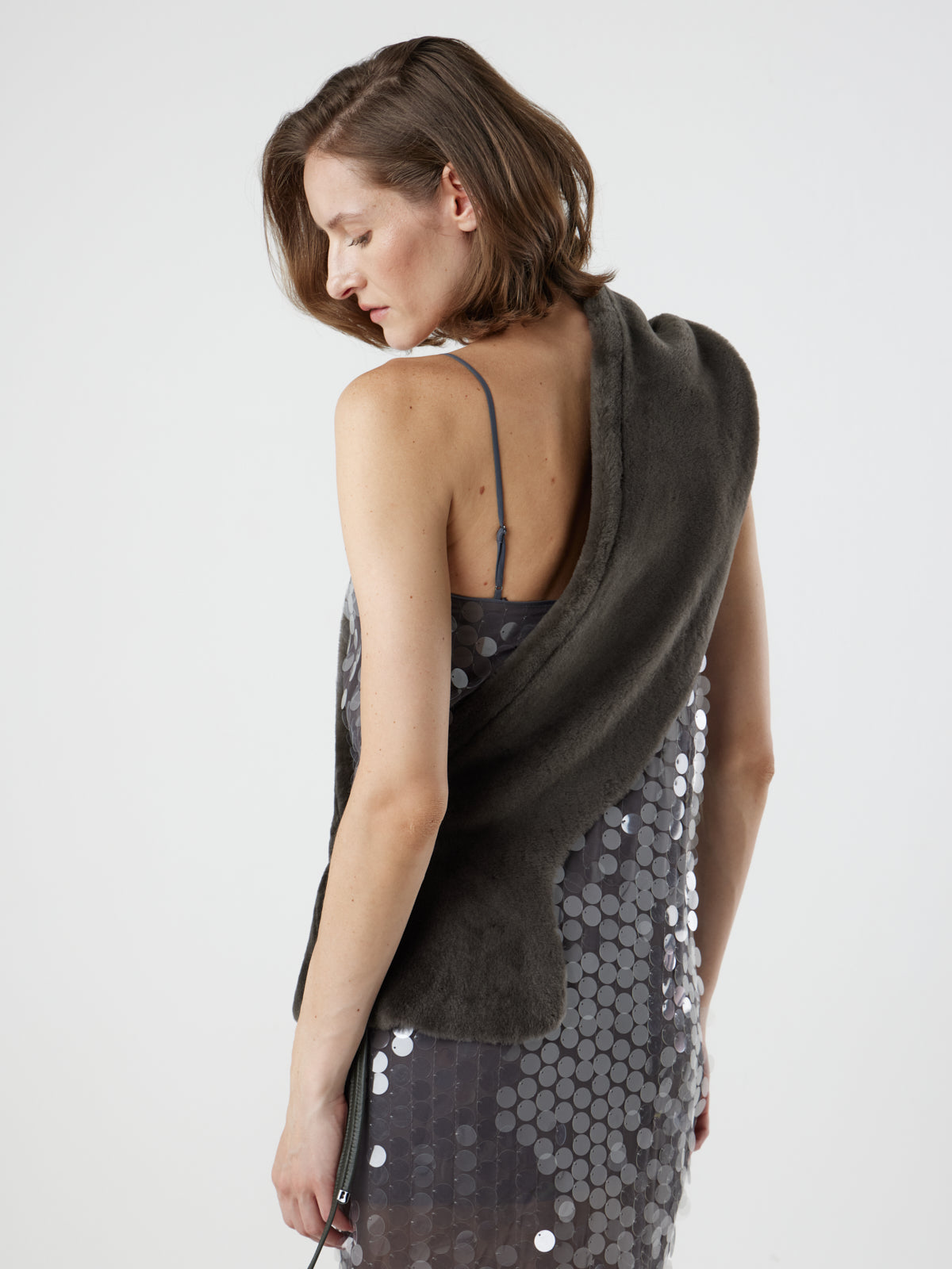 woman wearing storm brown shearling shawl scarf by gushlow & cole, styled as a sash