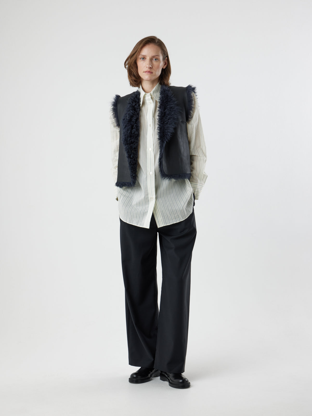 woman wearing two button navy shearling vest by gushlow & cole