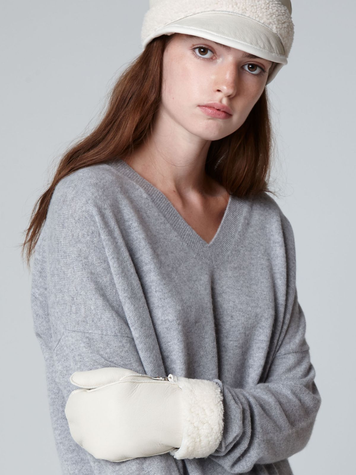 women wearing shearling cap and full palm shearling mittens by gushlow & cole on grey background