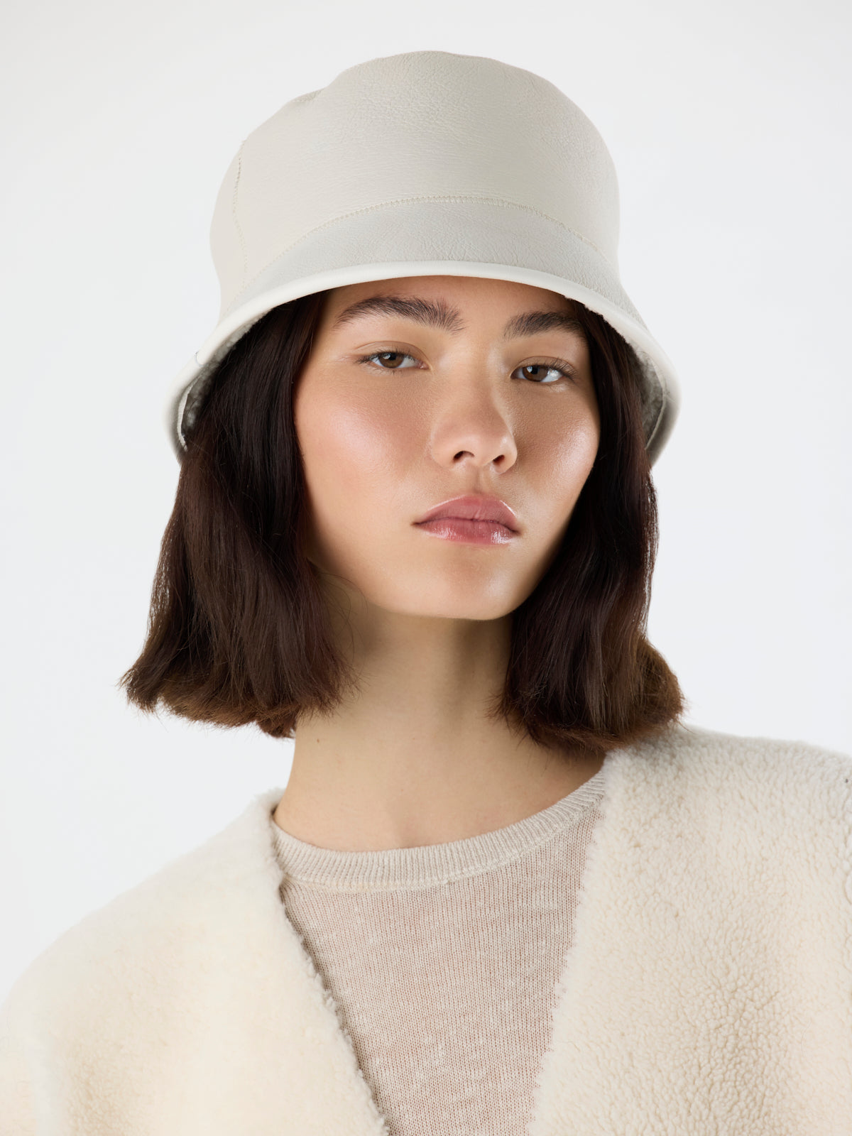 woman wearing white Shearling Bucket Hat with Leather Trim by gushlow & cole