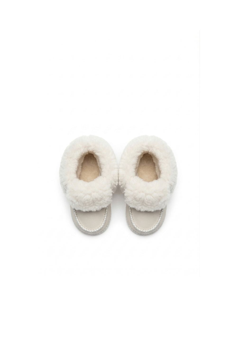 above view of pair of kids white sheepskin baby boots on white background by gushlow & cole - side view