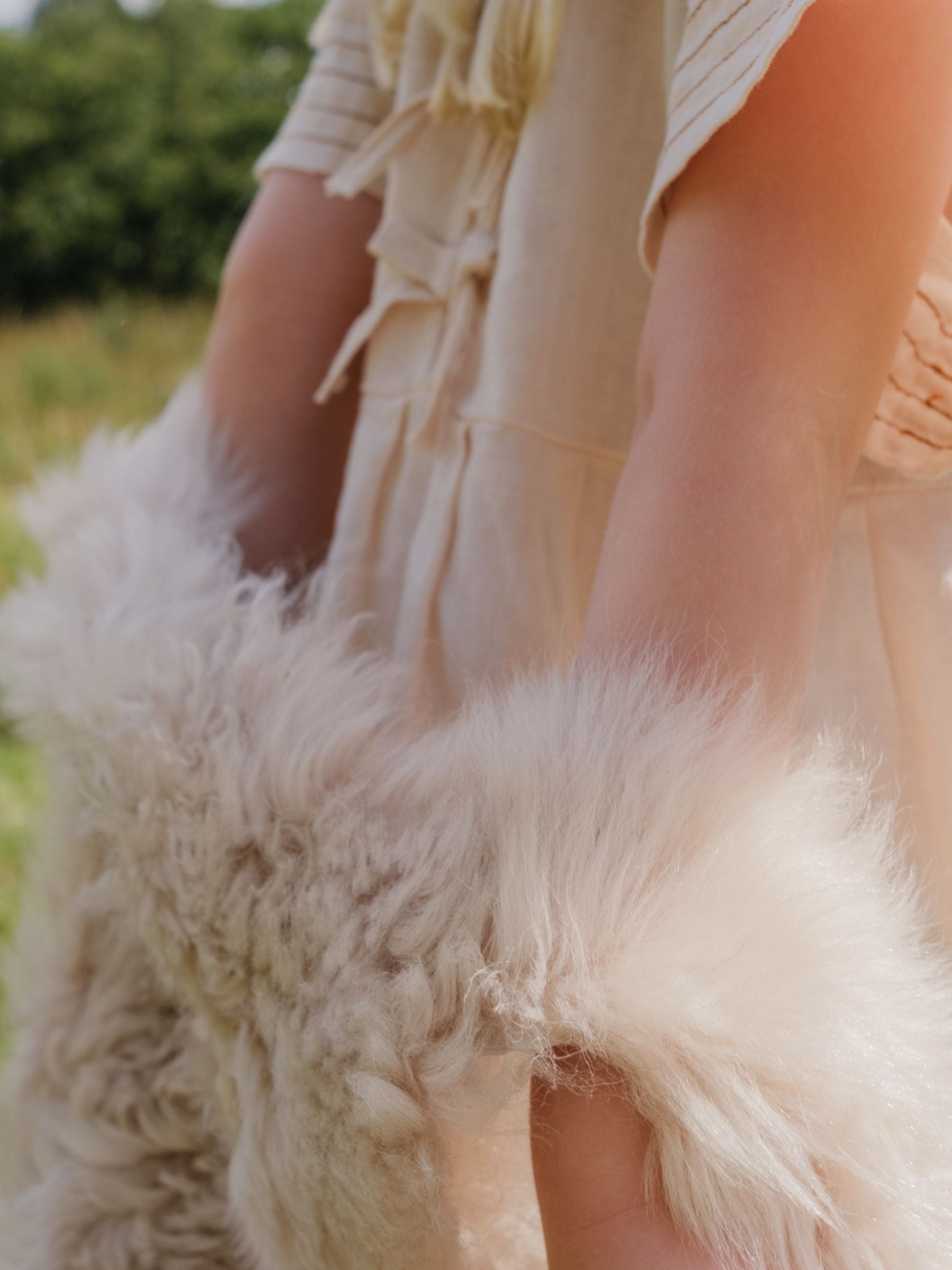 child wearing curly shearling gilet outside - luxury womens shearling gushlow & cole