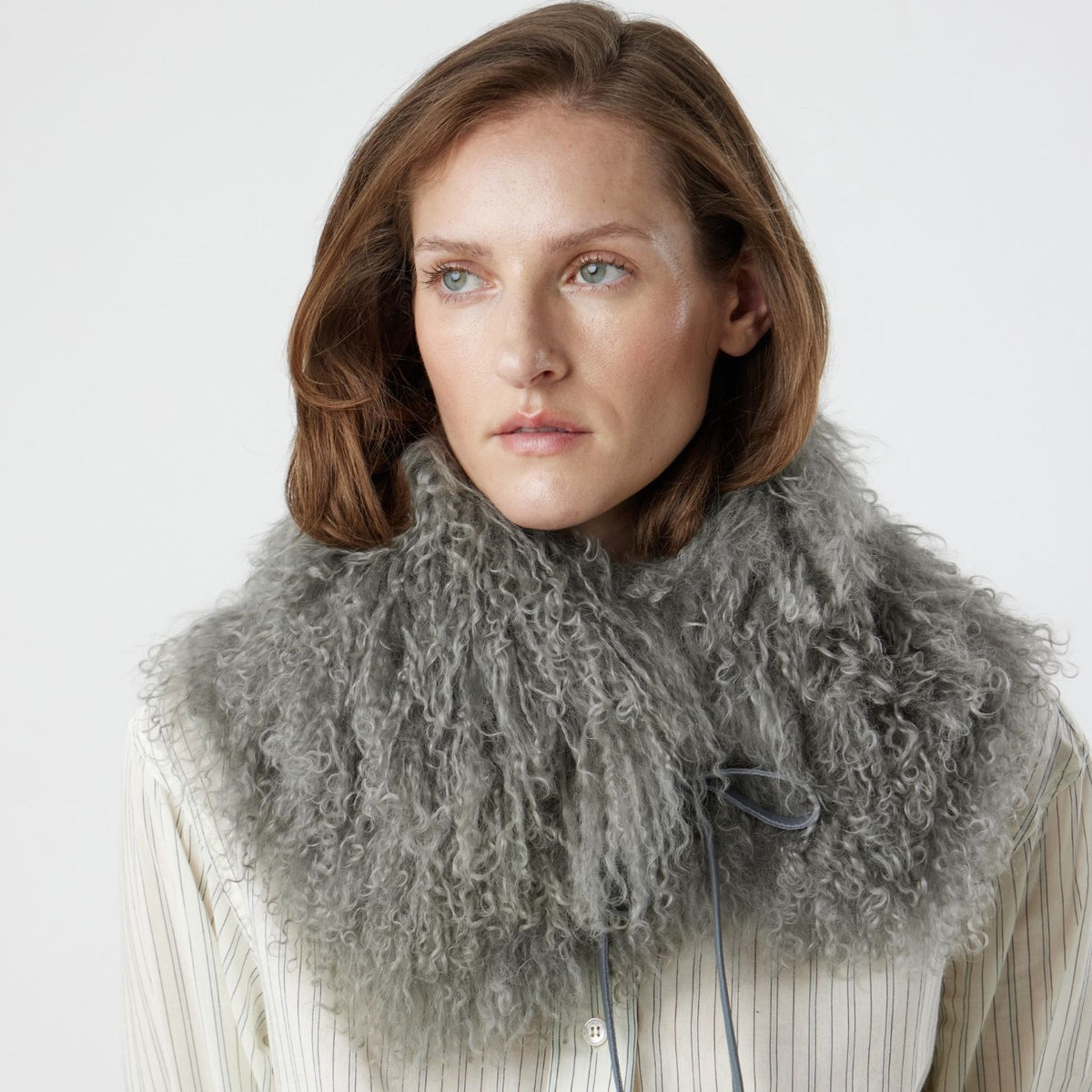 woman wearing grey mongolian shearling collar scarf by gushlow & cole