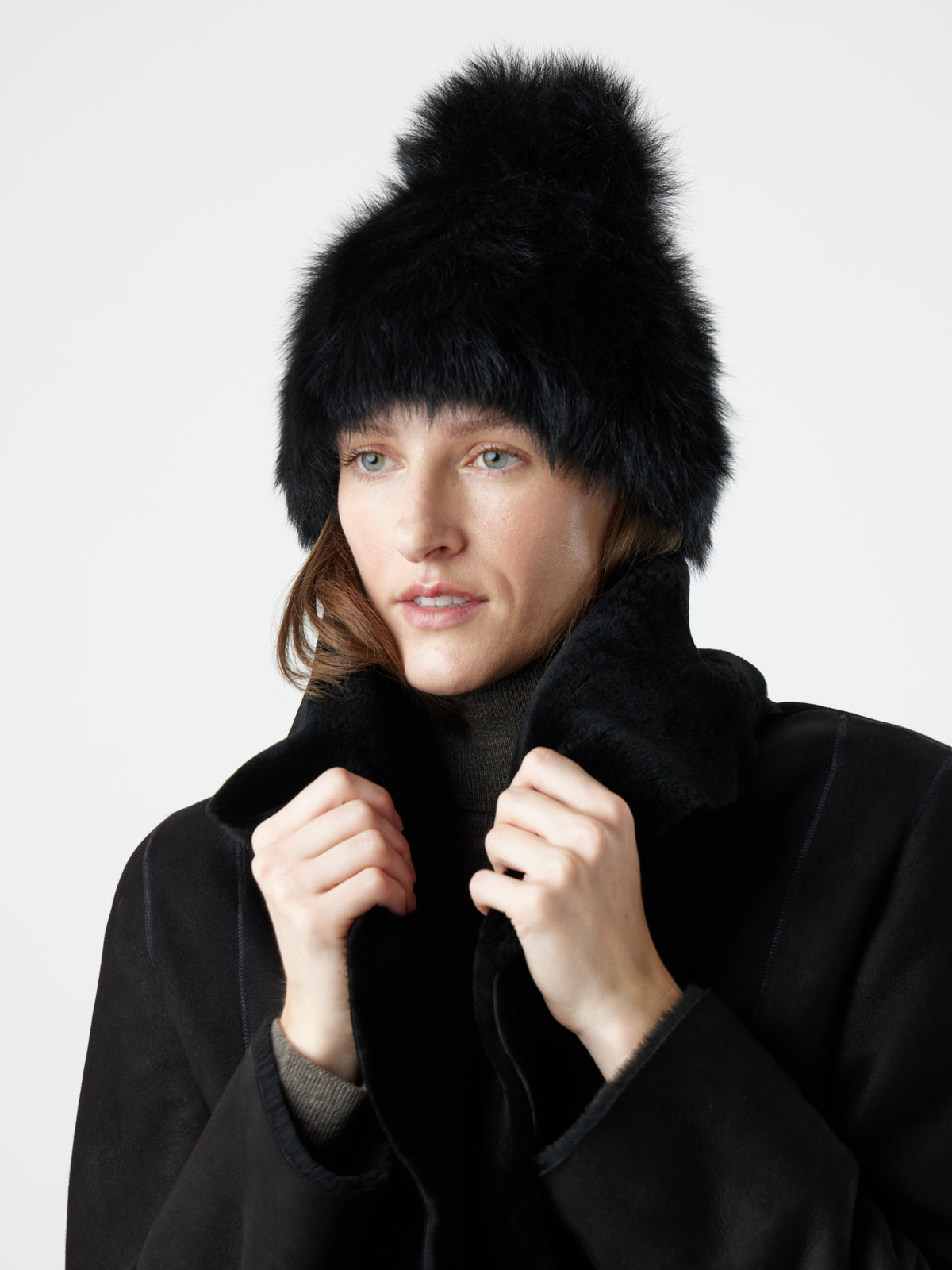 woman wearing Black Blanket Shawl Shearling Jacket and black toscana shearling beanie hat by gushlow & cole on white background 