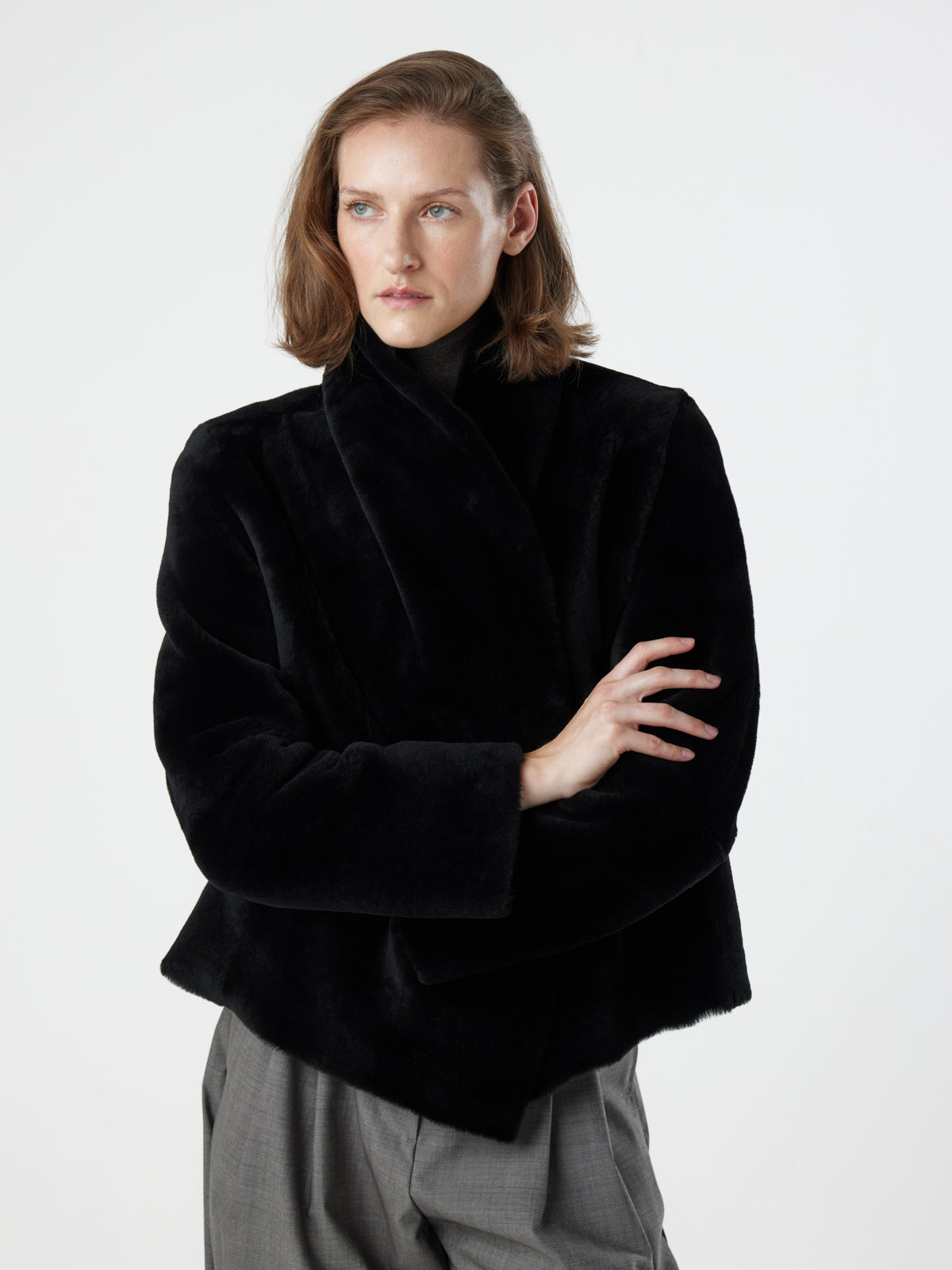 woman wearing reversed Black Blanket Shawl Shearling Jacket by gushlow & cole on white background with hands crossed