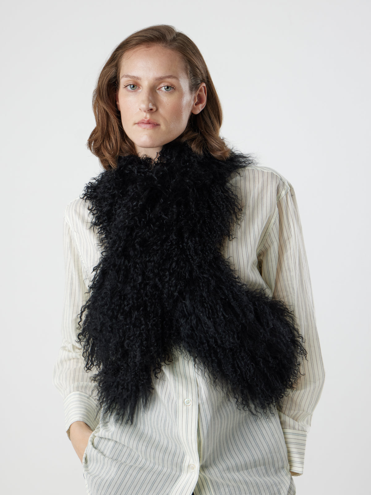 woman wearing black Mongolian Shearling sheepskin Shawl Scarf by gushlow & Cole crossed over body