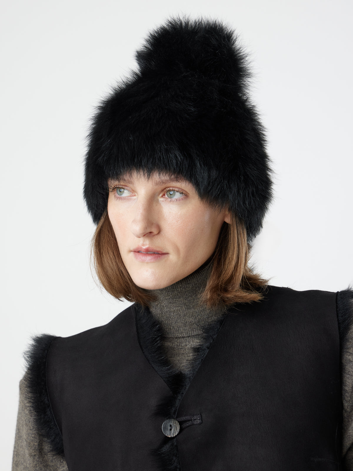 woman wearing black toscana shearling beanie hat by gushlow & cole