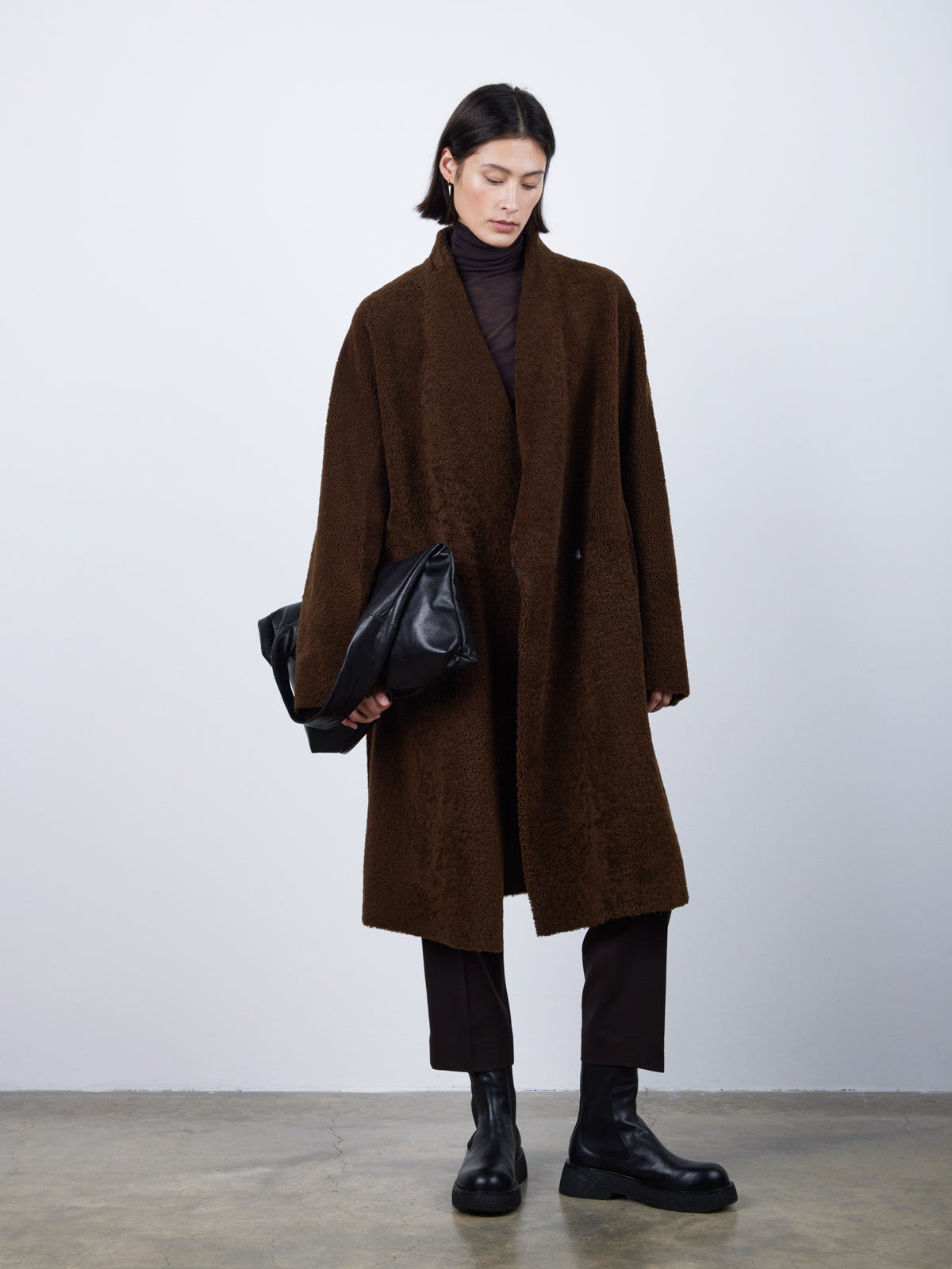 Brown Collarless Shearling Wrap Coat | Womens | Gushlow & Cole - model front with bag