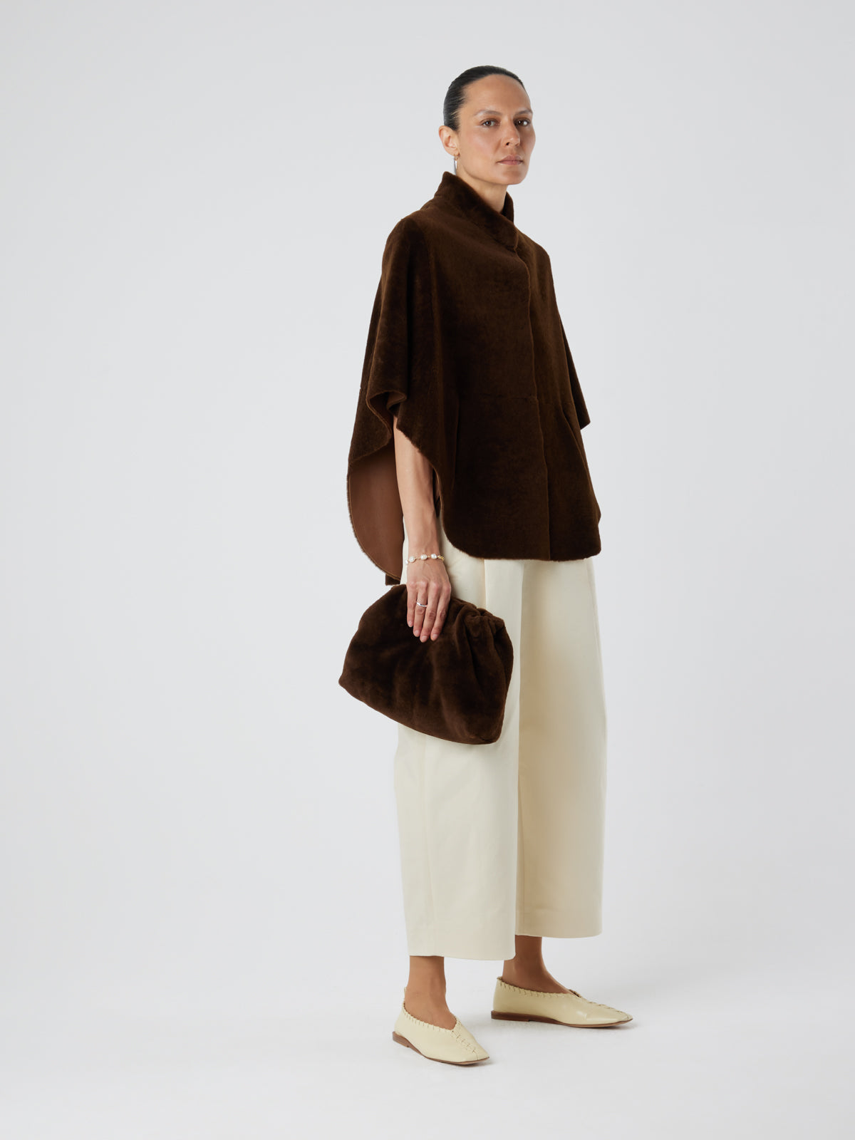 Brown Shearling Cape Jacket | Womens | Gushlow & Cole-full length on model holding bag